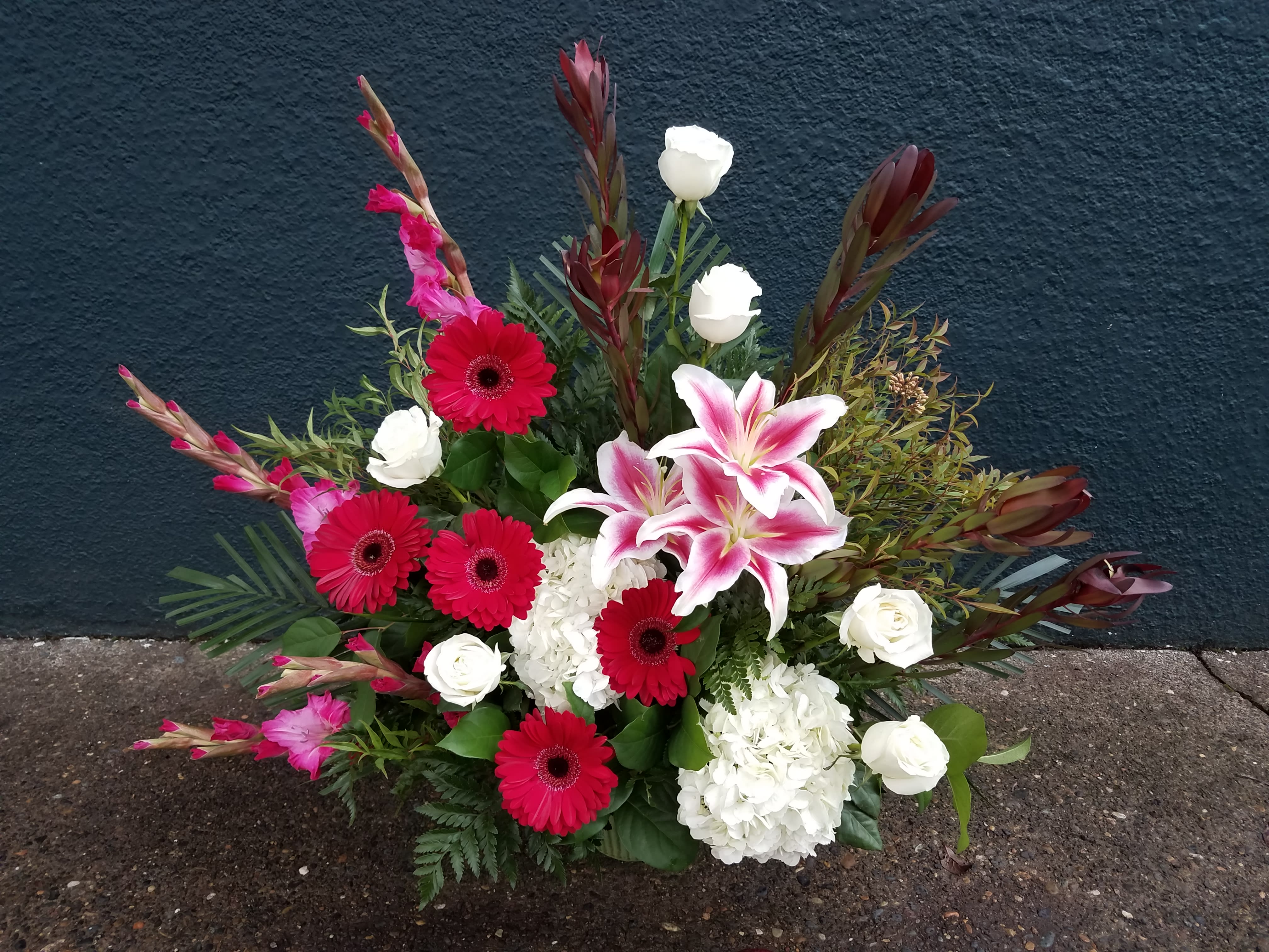 Mixed bouquet with pink lilies, red gerberas, and white roses
