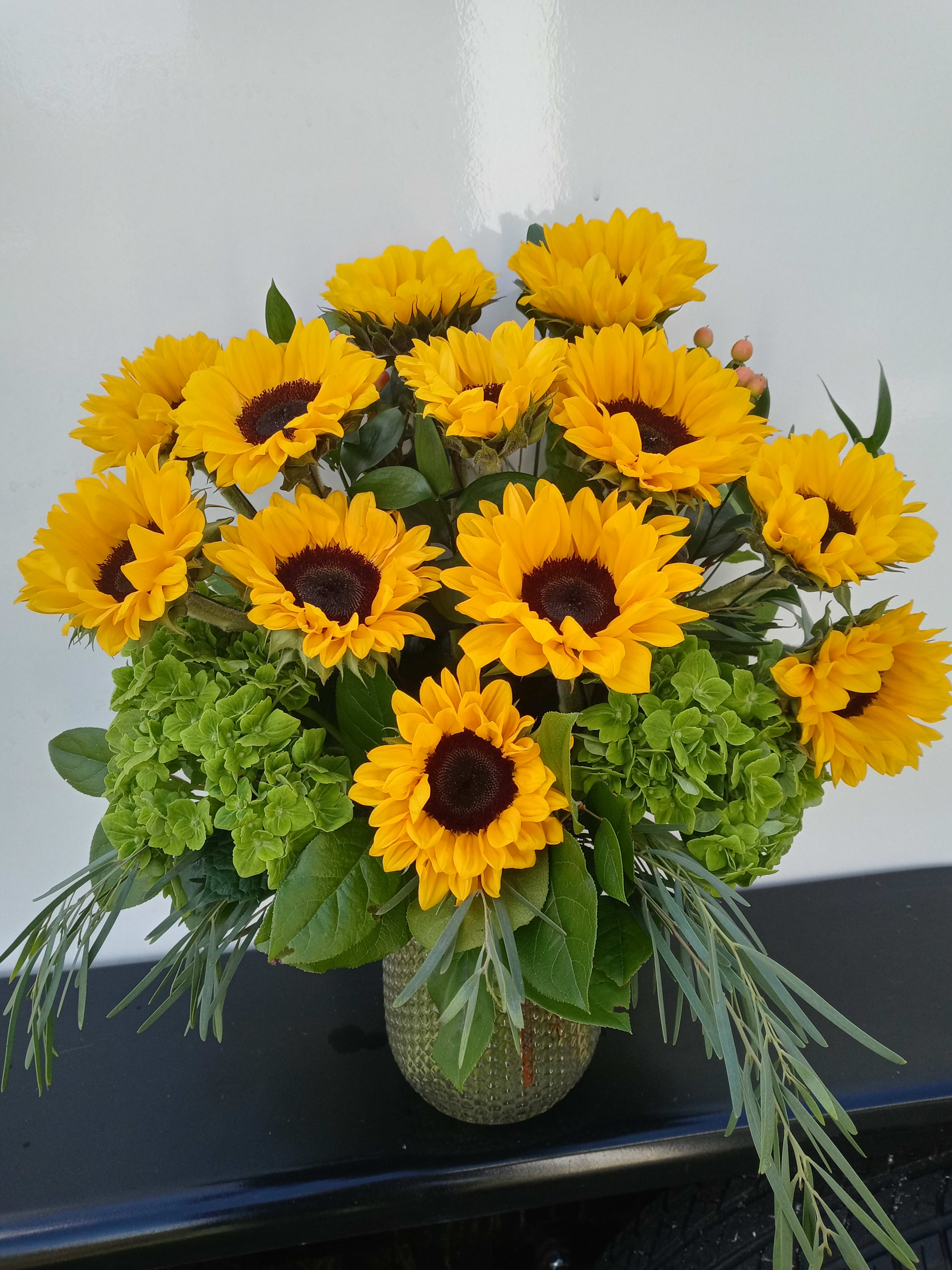 Bouquet of yellow sunflowers in a glass vase