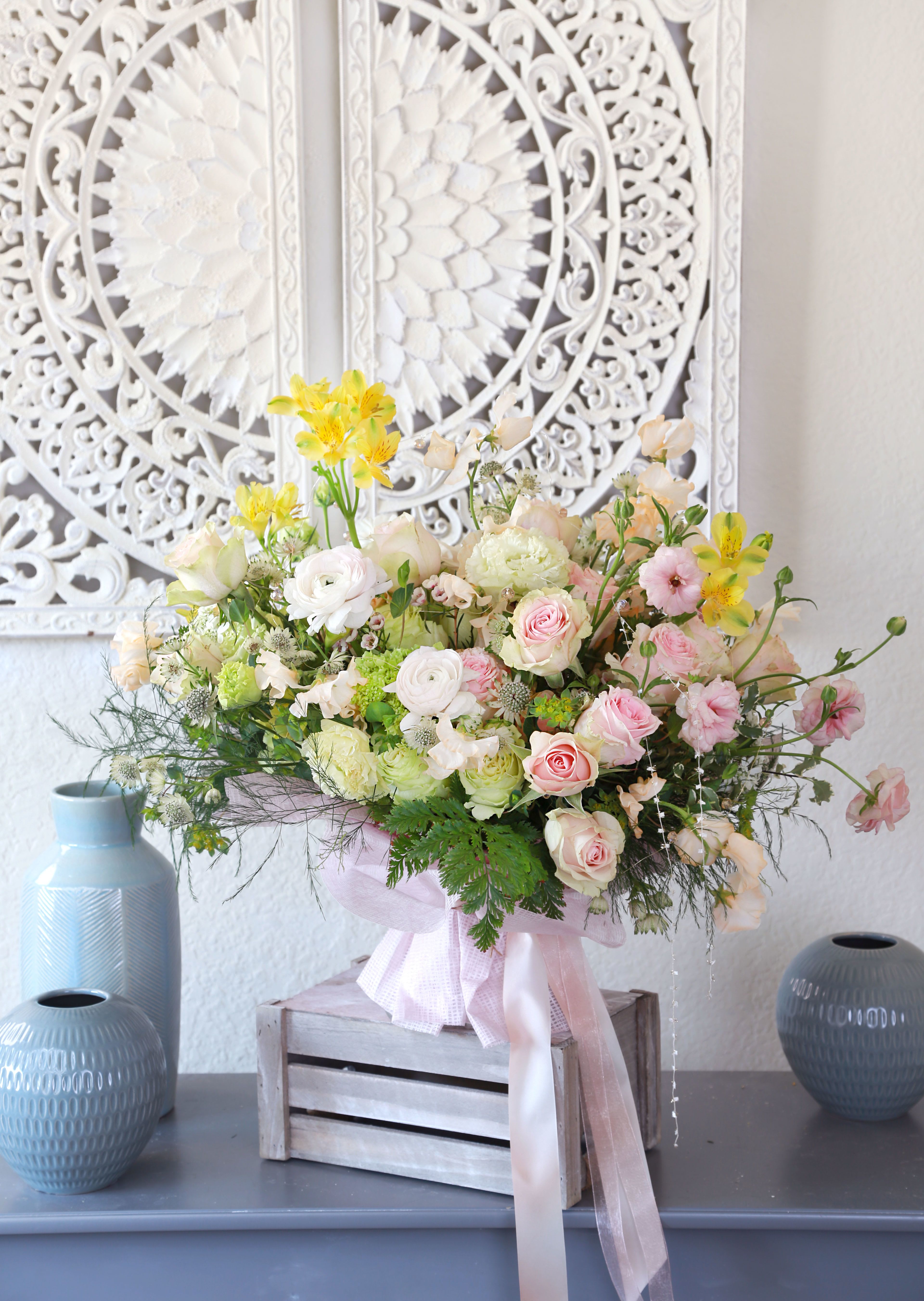 Spring whisper Garden - Pic shown as deluxe size. Features Blushes roses, ranunculus, sweet peas with fresh green and hints of yellow, artfully styled in refresh, organic garden look. Bouquet delivers with paper wrap, Vase is able to add on purchase with gift box.
