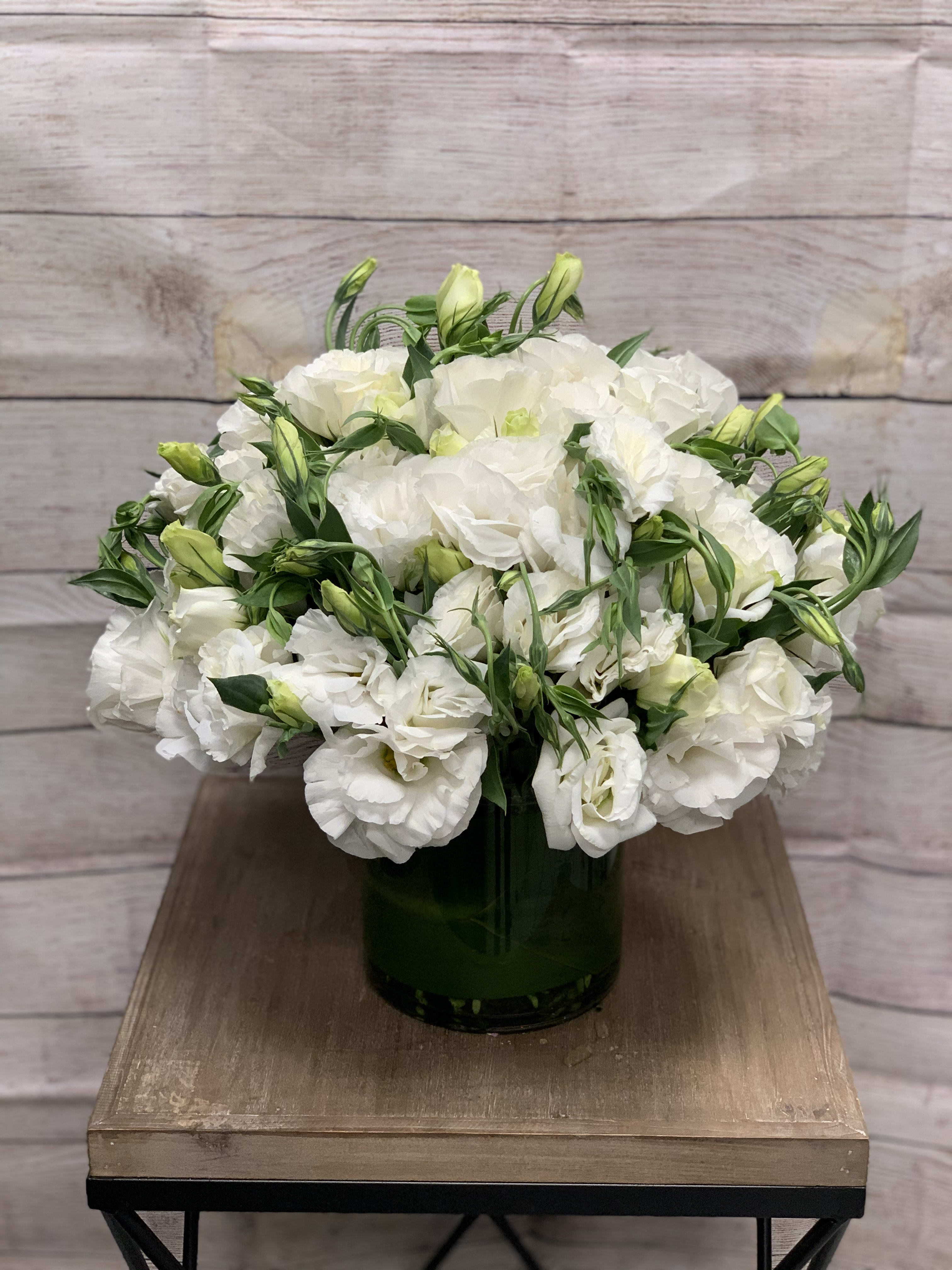 Cloud Nine  - An arrangement of white lisianthus and minimal greens destined to make you feel like you have your own personal piece of the sky.  NOTE: The arrangement displayed here is the upgraded, $225.00 value arrangement 
