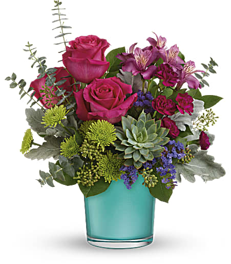 Pink roses and purple flowers in a turquoise glass vase