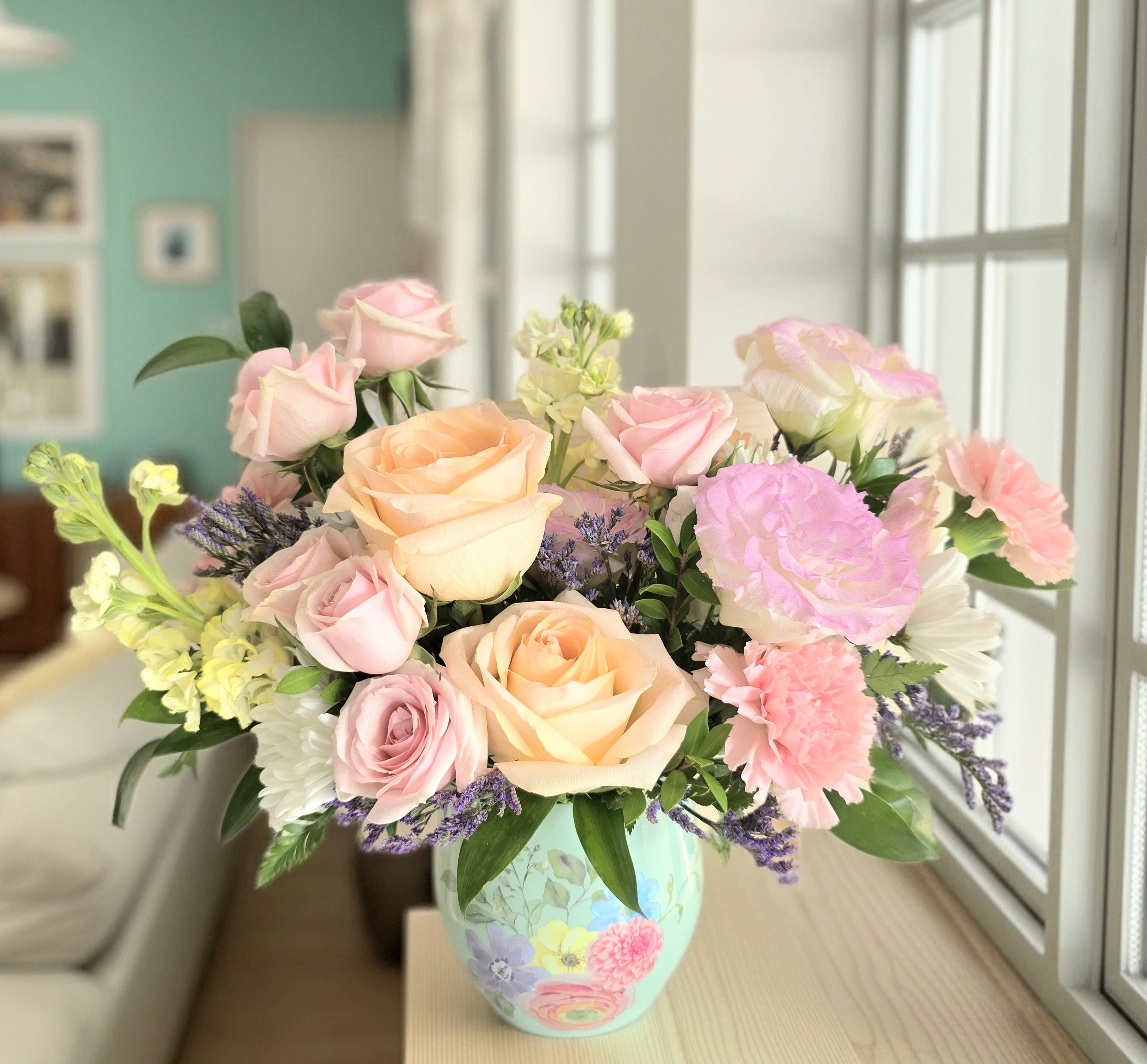 Pastel rose bouquet in a painted ceramic vase