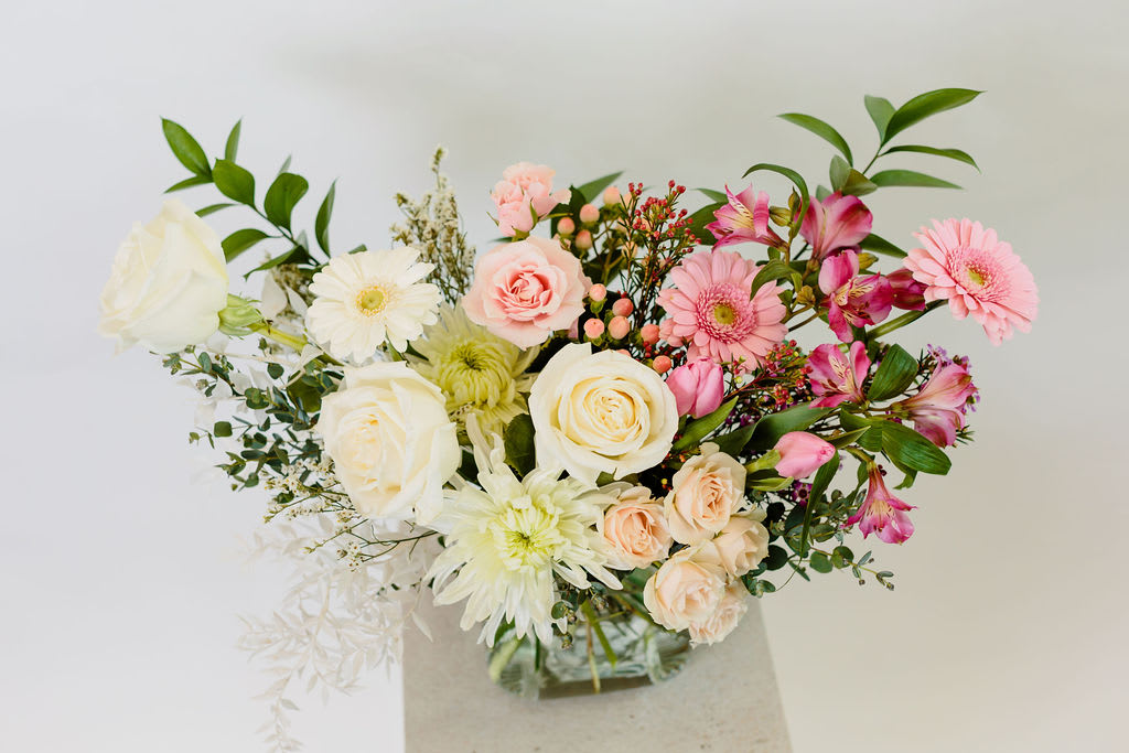Mixed bouquet of pink and white flowers in a vase