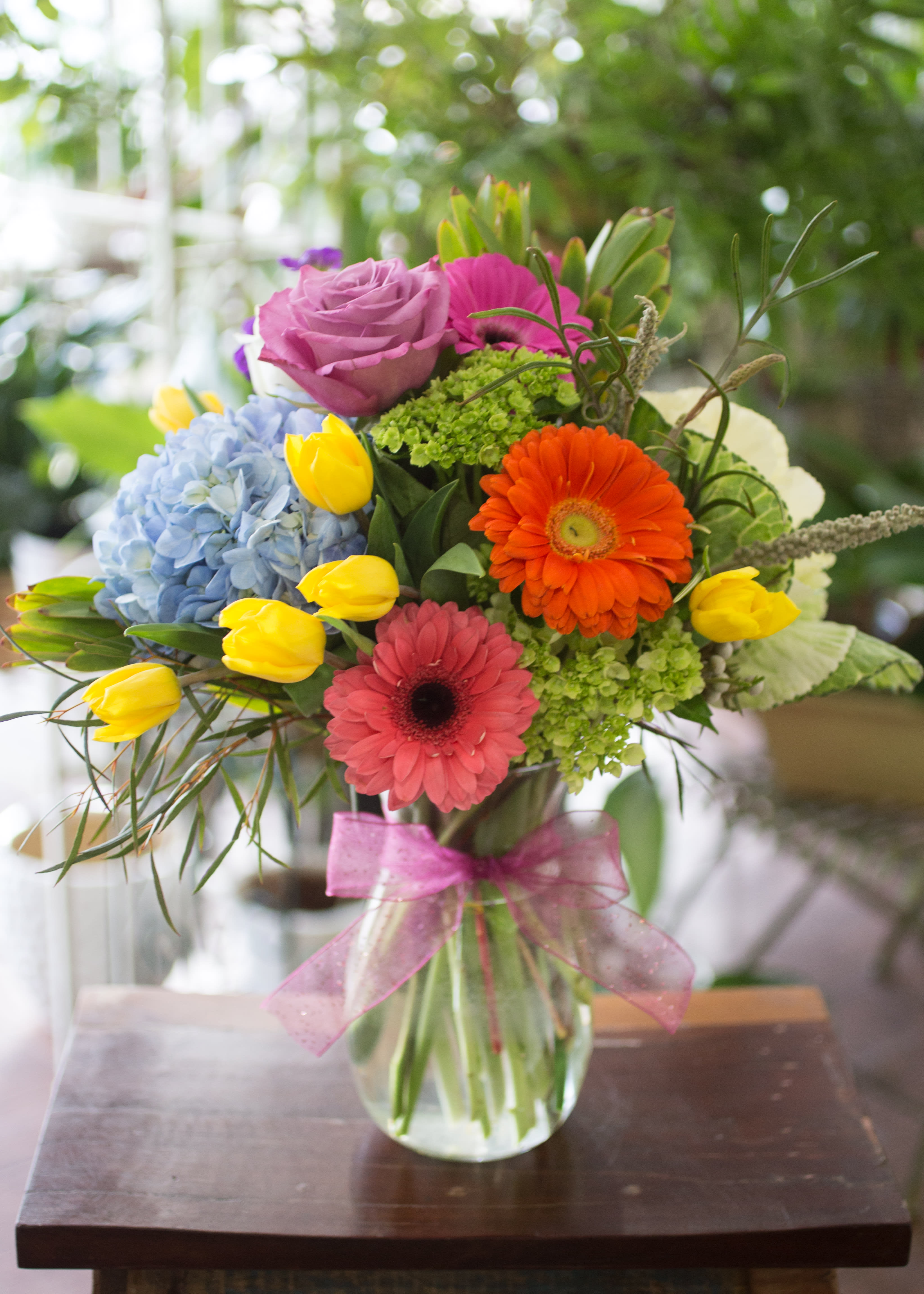 Francine - Tulips, Hydrangeas, Gerbera Daisies, Roses, Kale, so much color, arranged in a clear glass vase. 