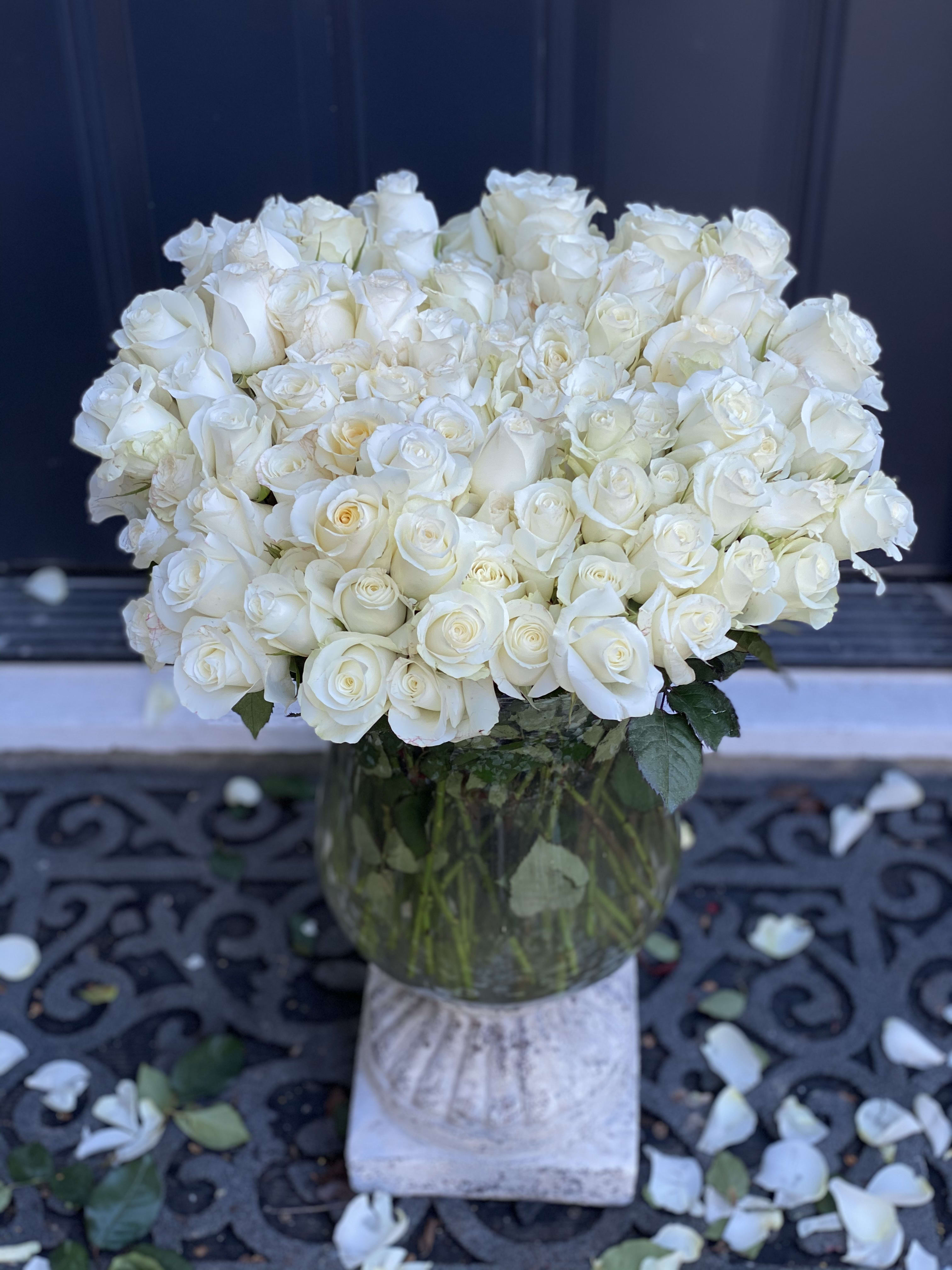 Large bouquet of white roses in a glass vase