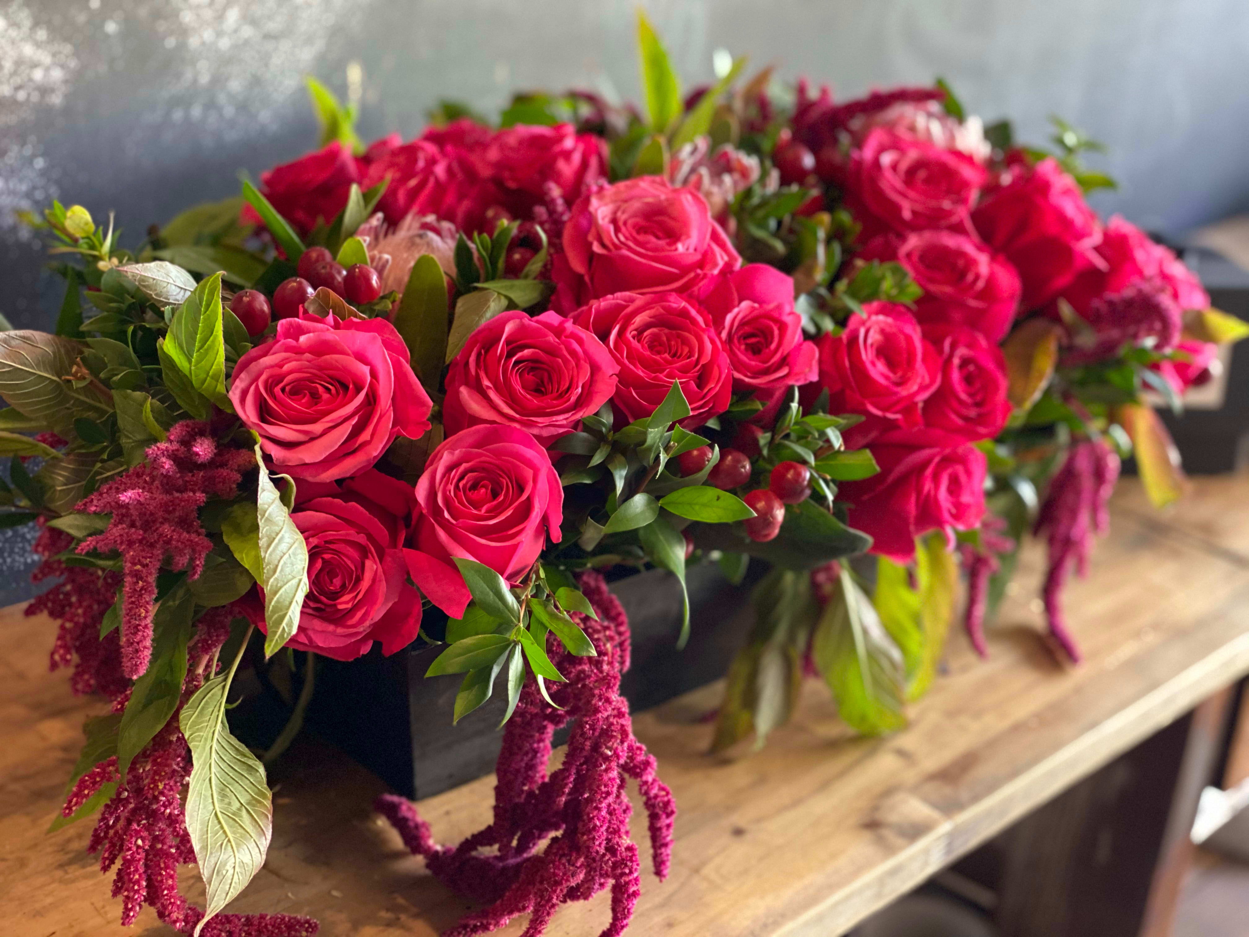 Pink rose arrangement in a black rectangular container