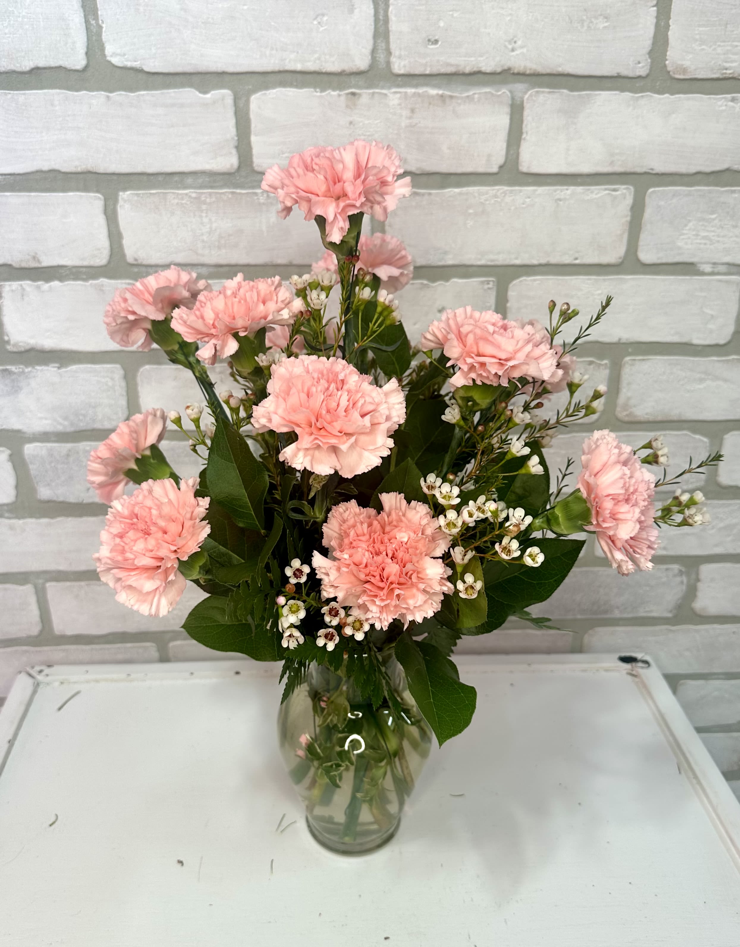 One Dozen Carnations - A dozen carnations *available in pink, red, and white.*