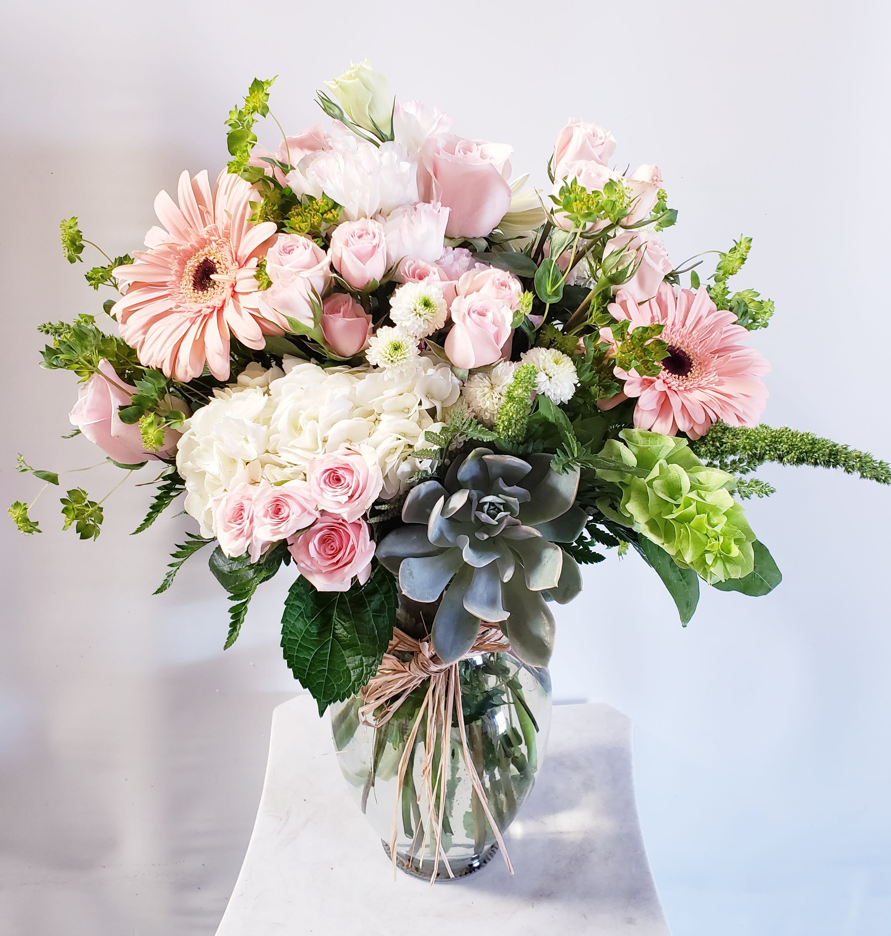 Pink and white mixed flower bouquet in a clear glass vase