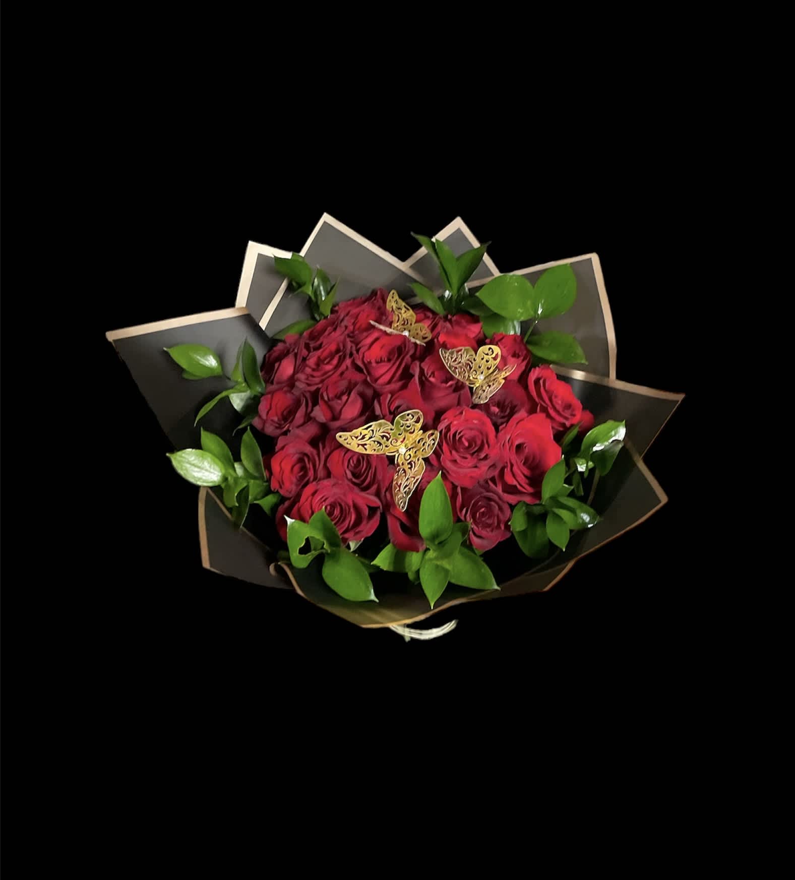 Bouquet of red roses with green foliage and butterfly accents