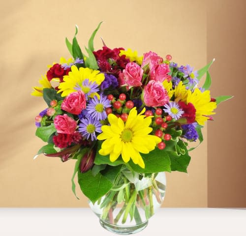 Colorful mixed bouquet in a clear glass vase