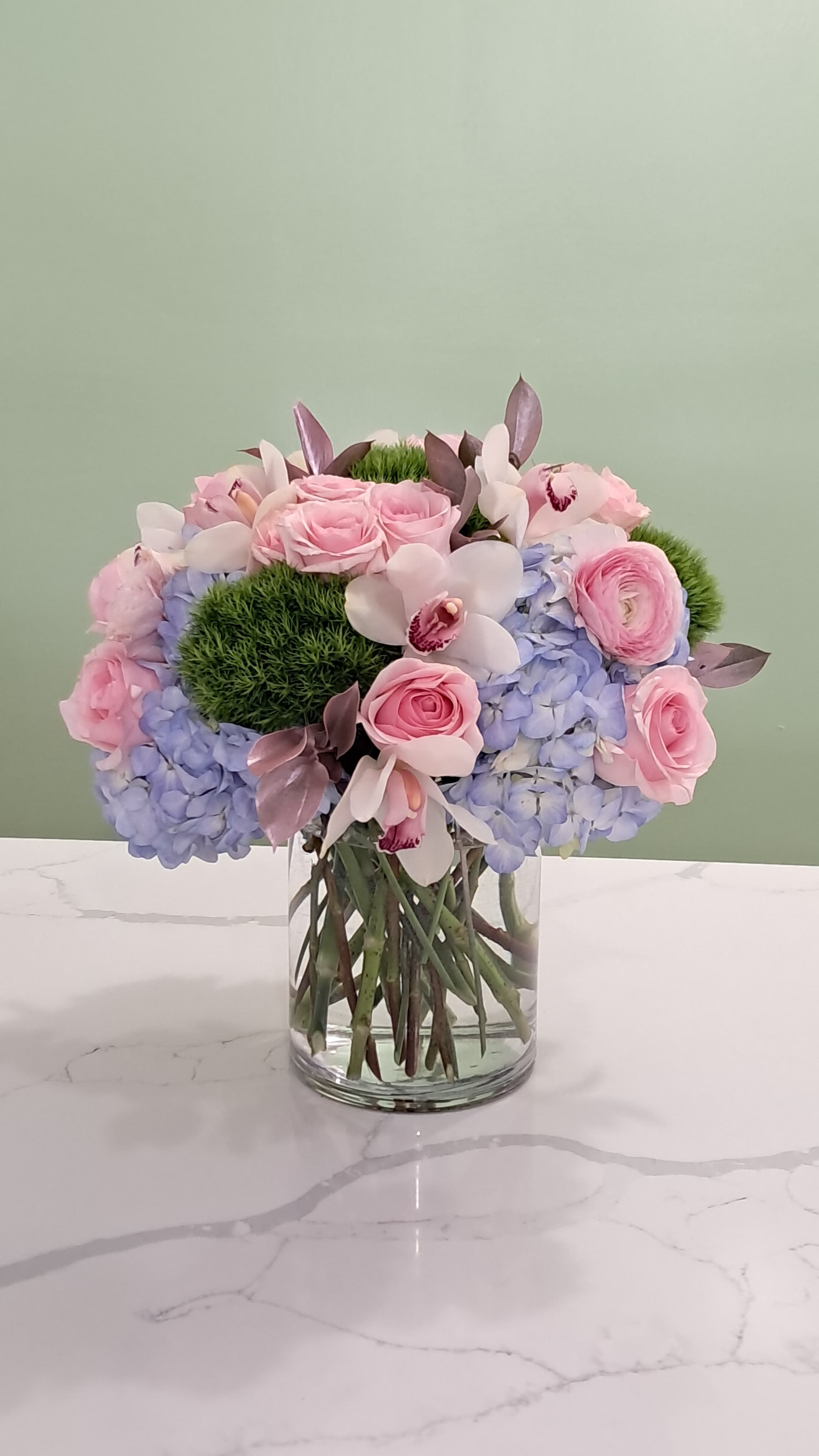Petal Poetry  - Soft pinks, pretty blues, and those gorgeous orchids all come together in the perfect bouquet. 