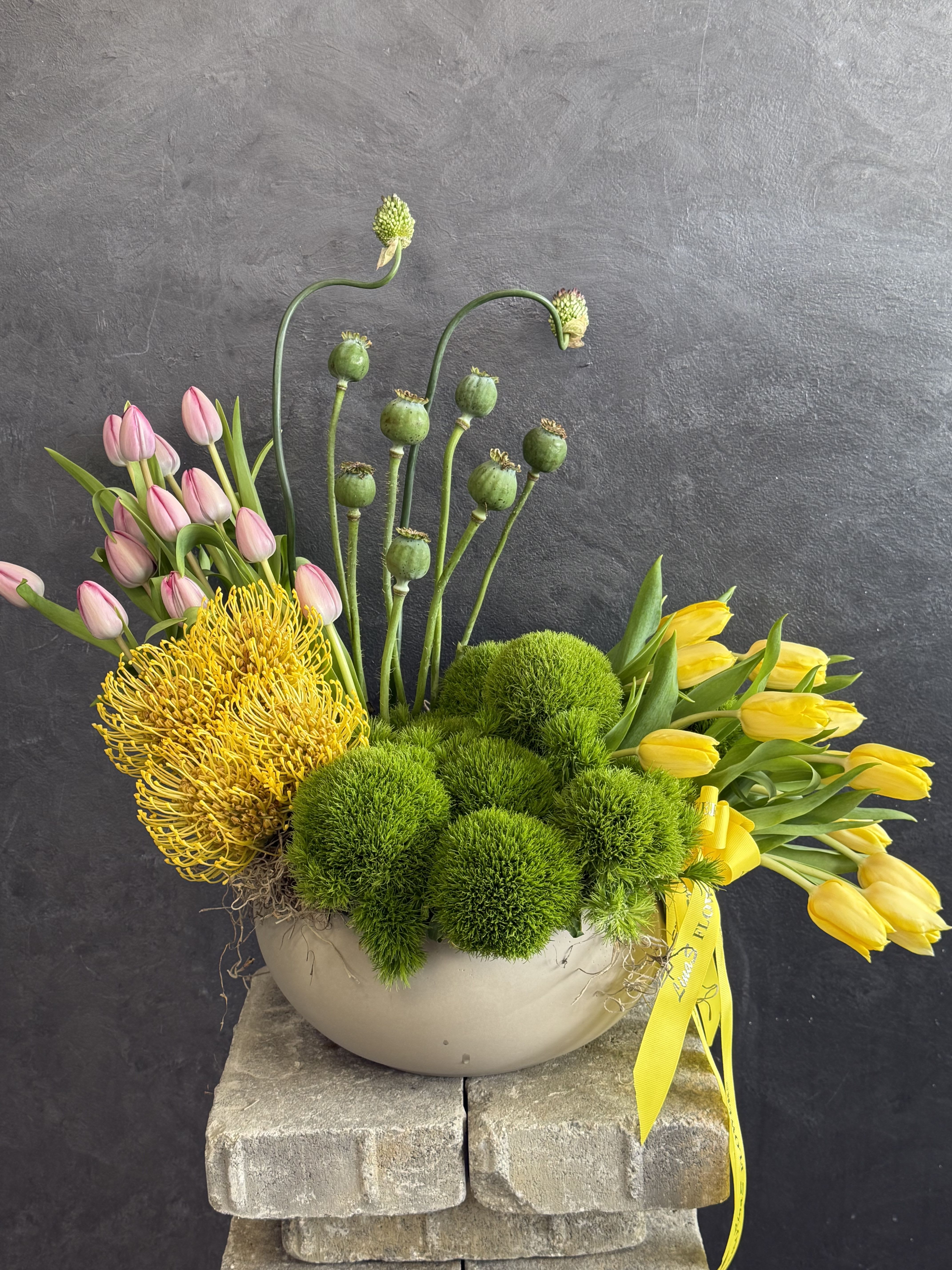 Luka - A vibrant garden arrangement with cheerful tulips, lush green textures, and exotic floral accents — bringing freshness, elegance, and natural beauty into every space.