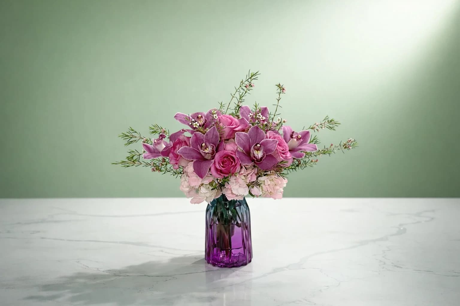 Orchid Dreams - Bright, beautiful, and totally gift-worthy! This gorgeous mix of pink orchids, roses, and hydrangeas in a pretty purple vase will make their day unforgettable.