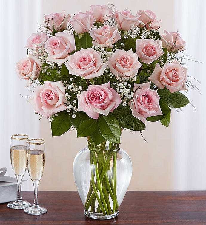 18 Light Pink Roses - Our elegant pink roses are a charming surprise for someone you care about deeply. Beautifully arranged by one of our expert florists with lush greenery inside a classic glass vase, pretty blooms are hand-delivered and ready to delight the people you love for big celebrations and every “just because” moment in between.   To guarantee the freshest bouquet possible, we may replace some stems in your arrangement for color or flower variety. While we always do the best to match the picture shown, sometimes different vases may be used. Any substitution made will be similar to the original design and be of equal or greater value.