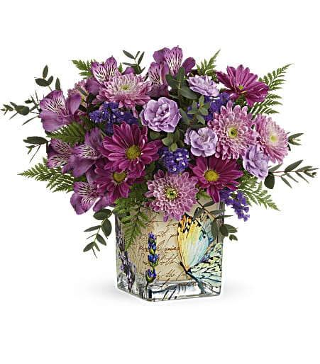 Purple mixed bouquet in a butterfly-printed square vase