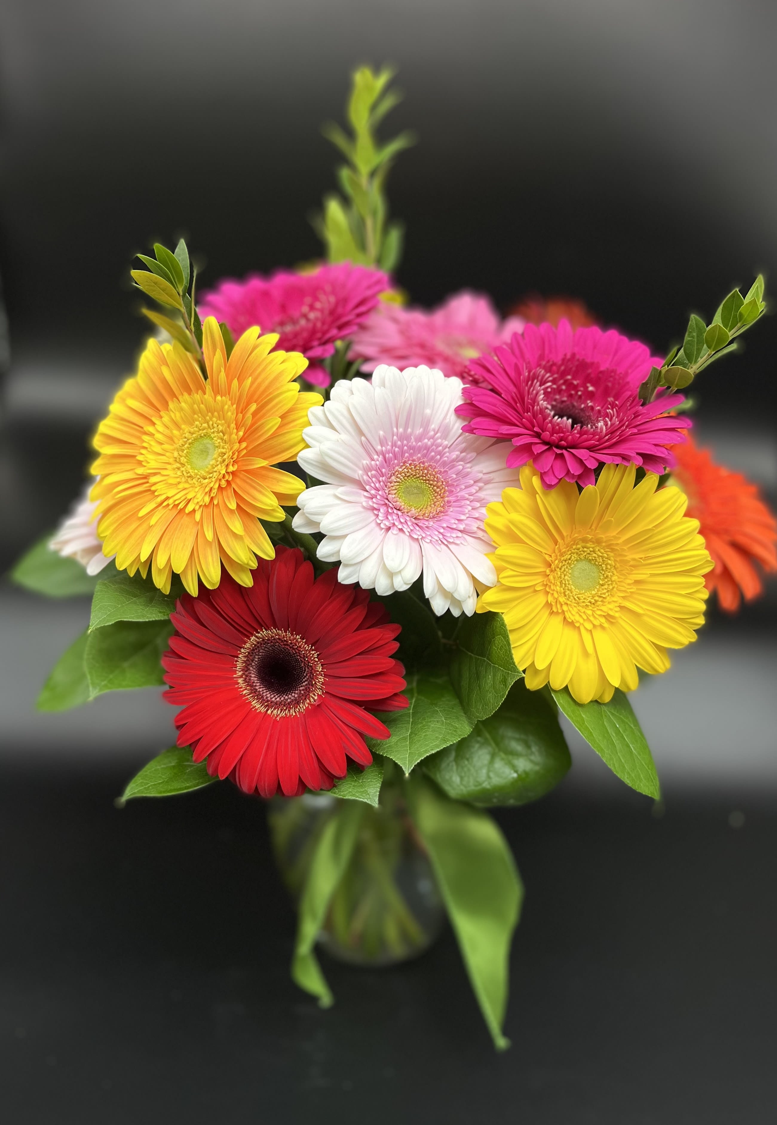 Bright gerbera daisy bouquet in a glass vase