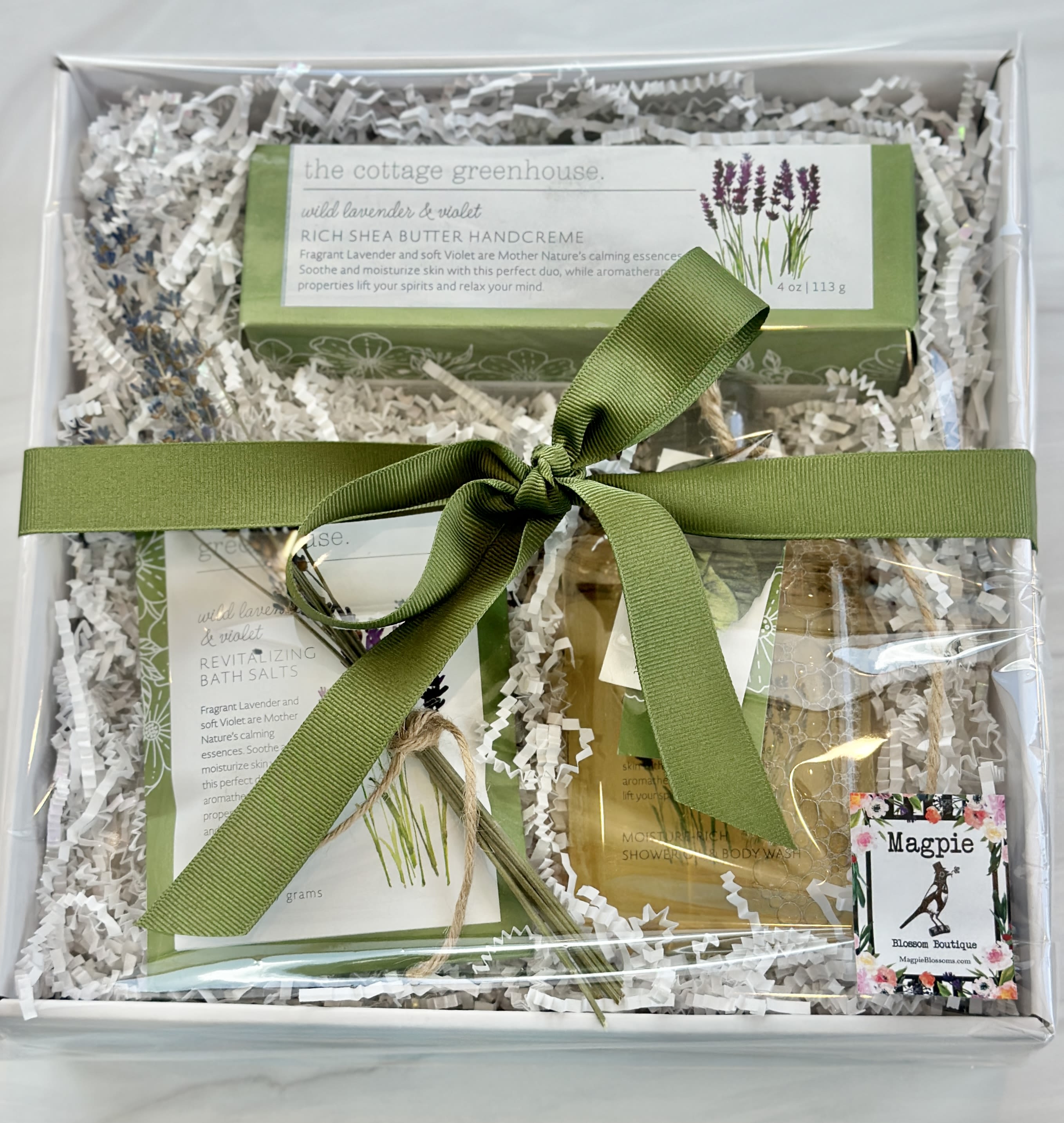 Gift box with lavender bath products tied with a green ribbon