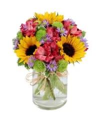 Florist Choice Small Arrangement - Mixed Florals and greens in a clear jar tied with twine - a cheerful, rustic small arrangement for everyday smiles and casual celebrations.