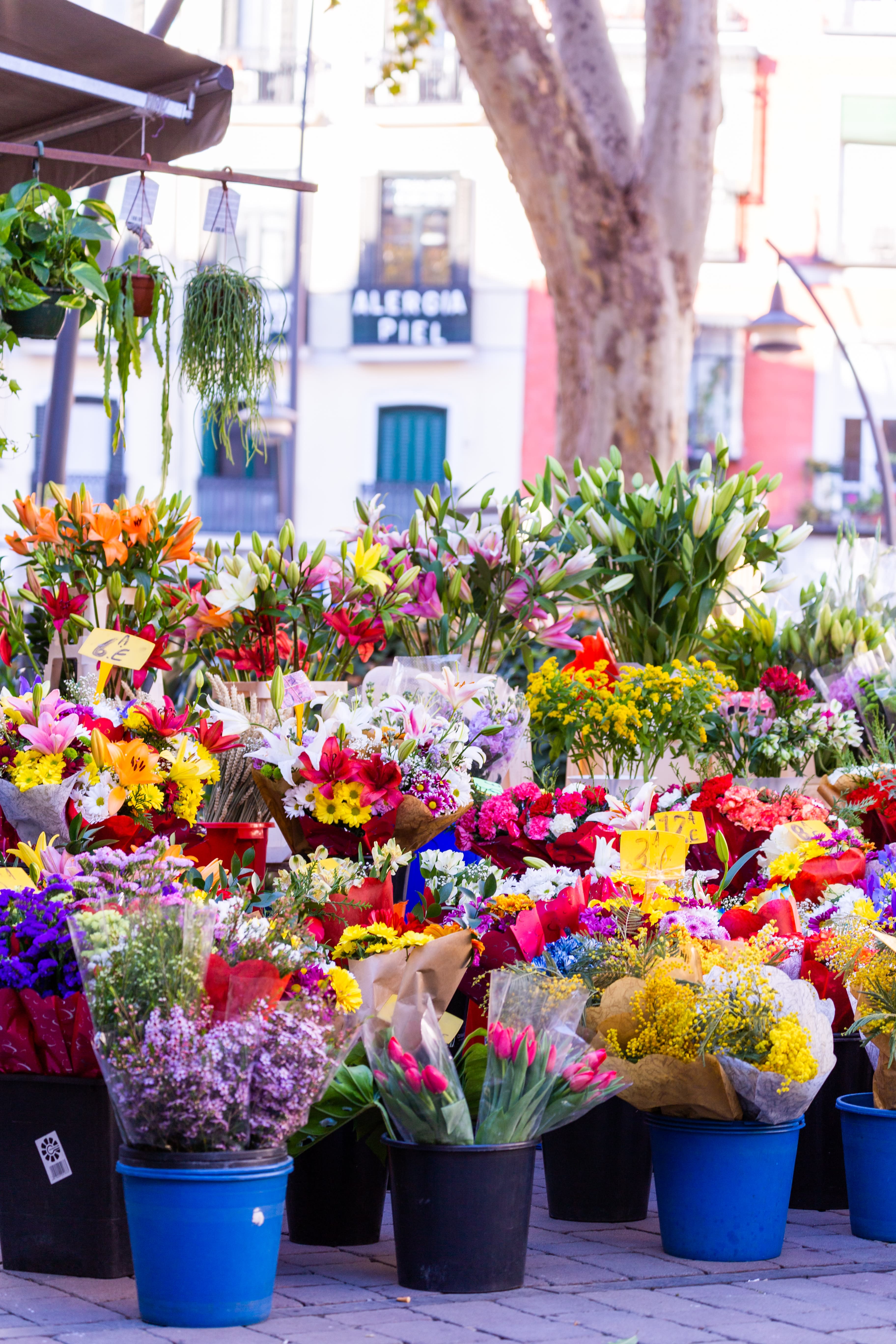 Outdoor flower market with colorful bouquets in buckets