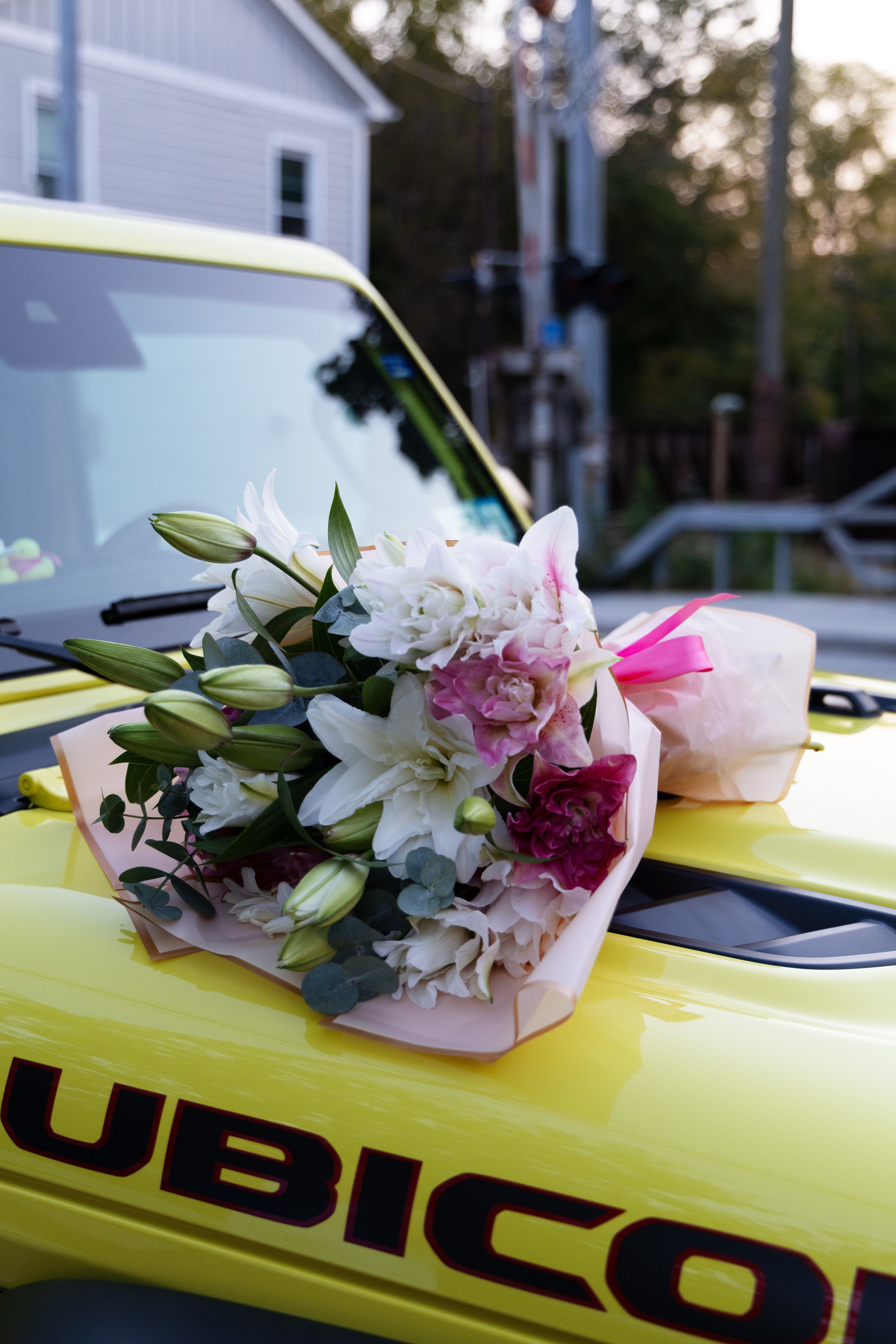 Bouquet of white and pink lilies wrapped in pale paper