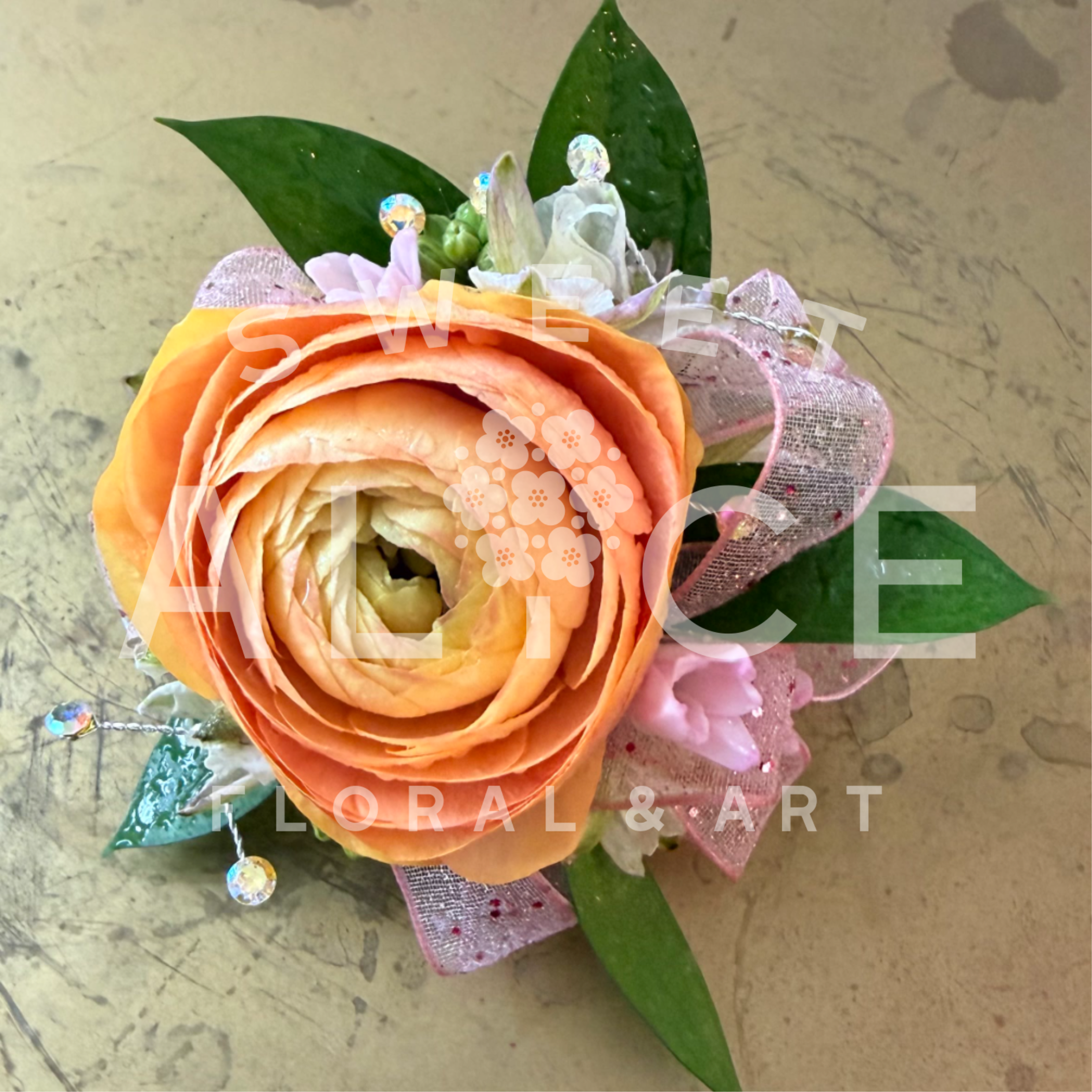 Romantic Ranunculus Corsage - Lovely ranunculus with ribbon, gemstones and greens.  Built onto a lovely silk ribbon wristband that ties to accommodate any wrist size.  Please note specific color requests in the notes section of your order.  * Corsage only.