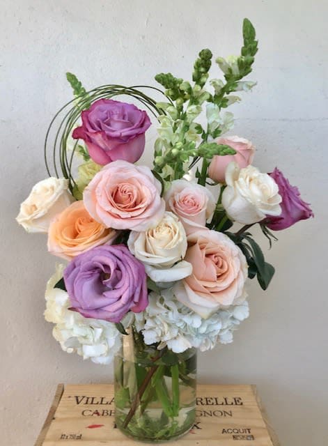 Bouquet of pastel roses in a clear glass vase