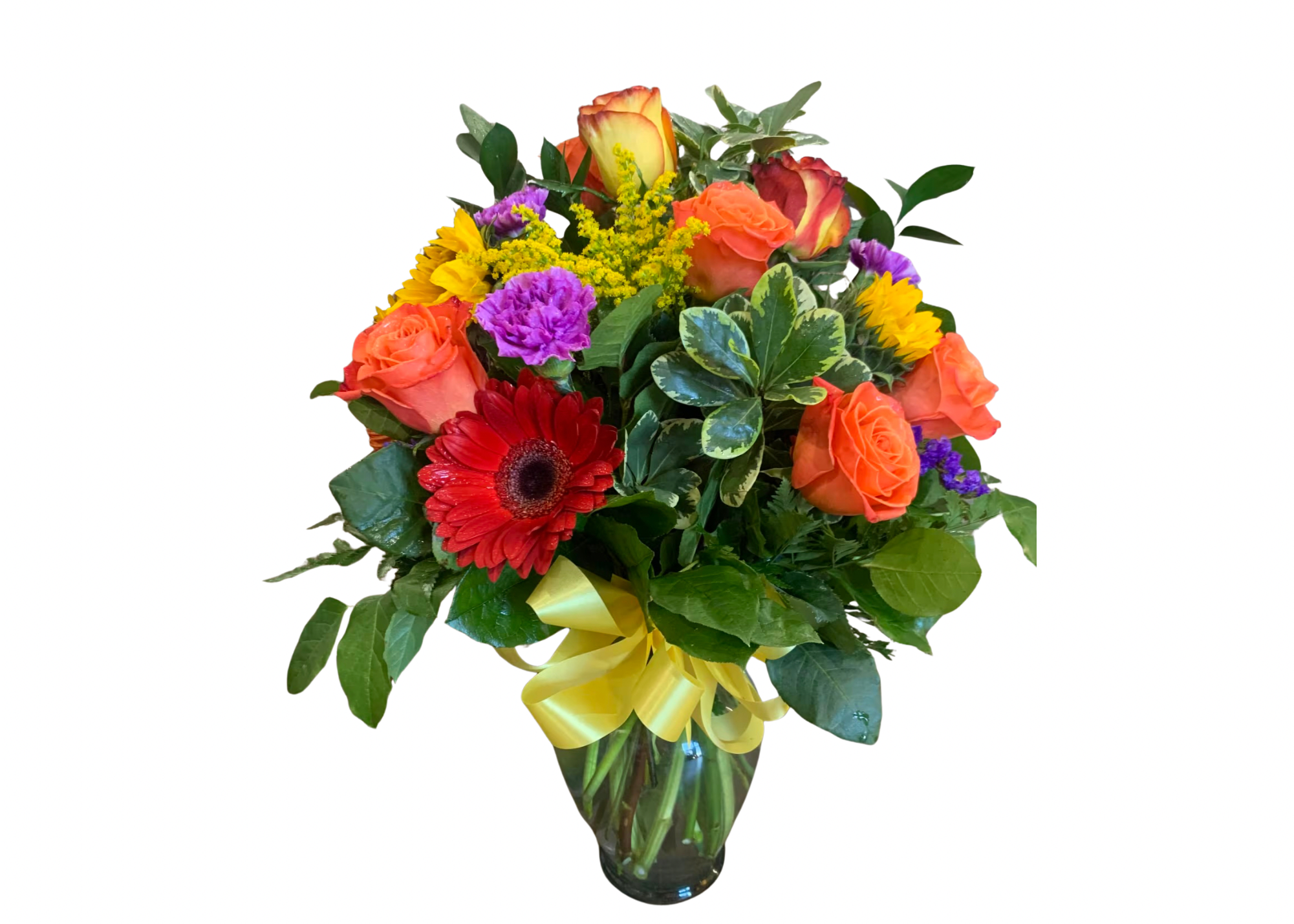 Mixed bouquet of roses, gerbera daisies, and carnations in a glass vase