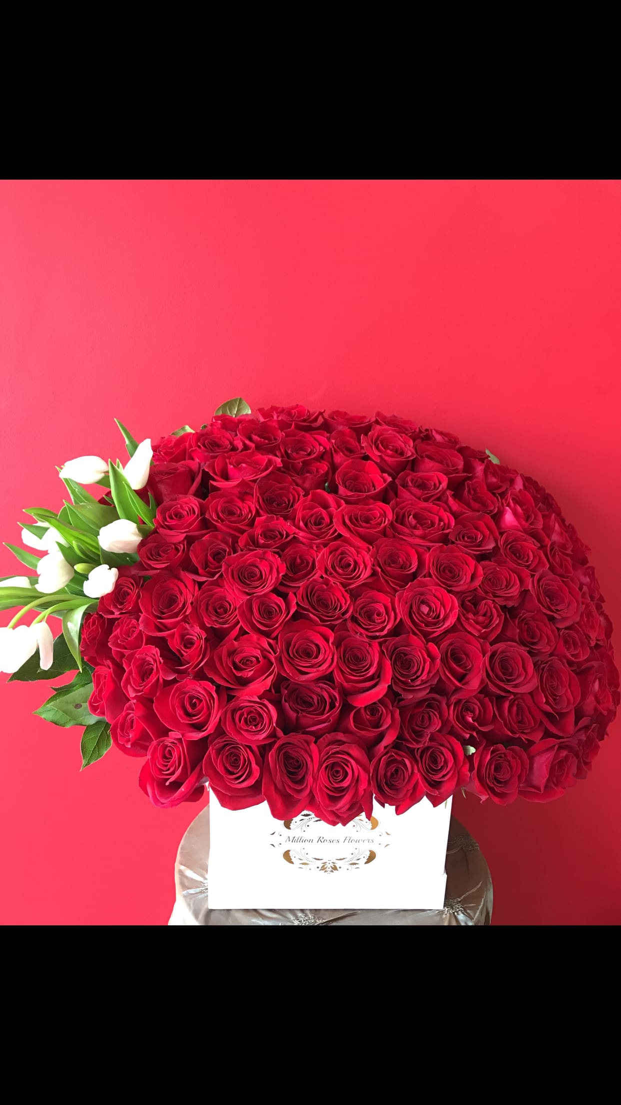 Large bouquet of red roses with white tulips in a white box