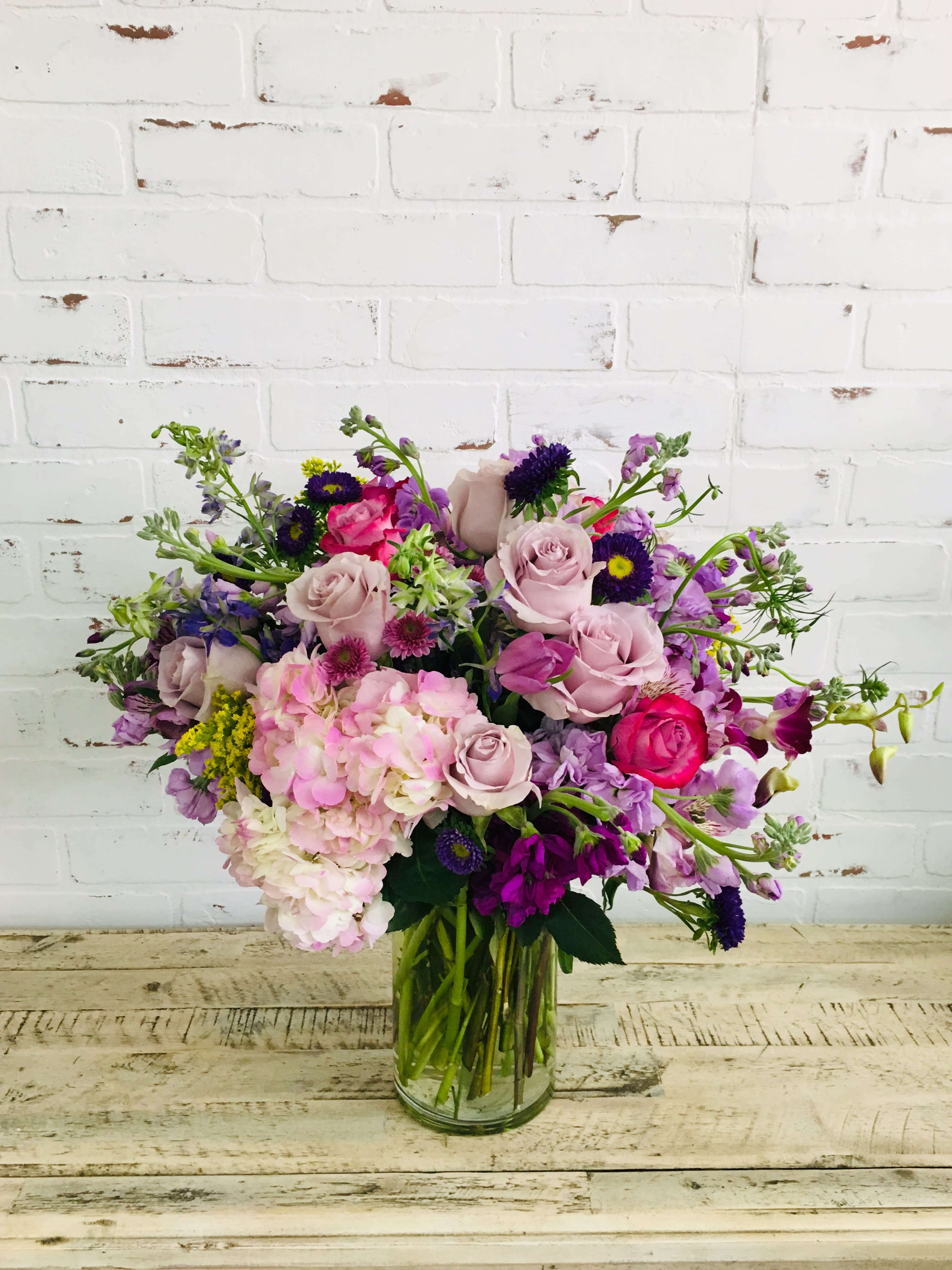 Mixed pink and purple bouquet in a clear glass vase