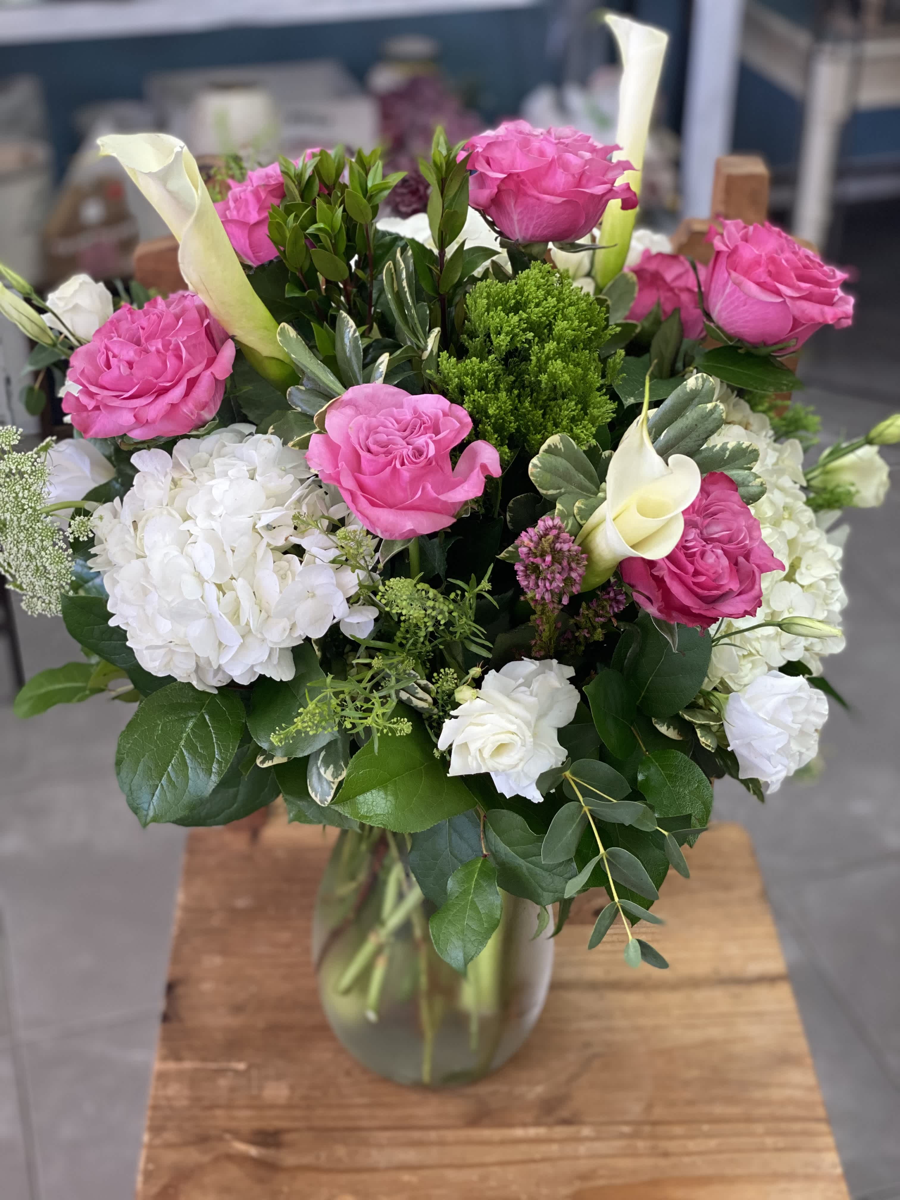 Pink roses and white hydrangeas in a glass vase