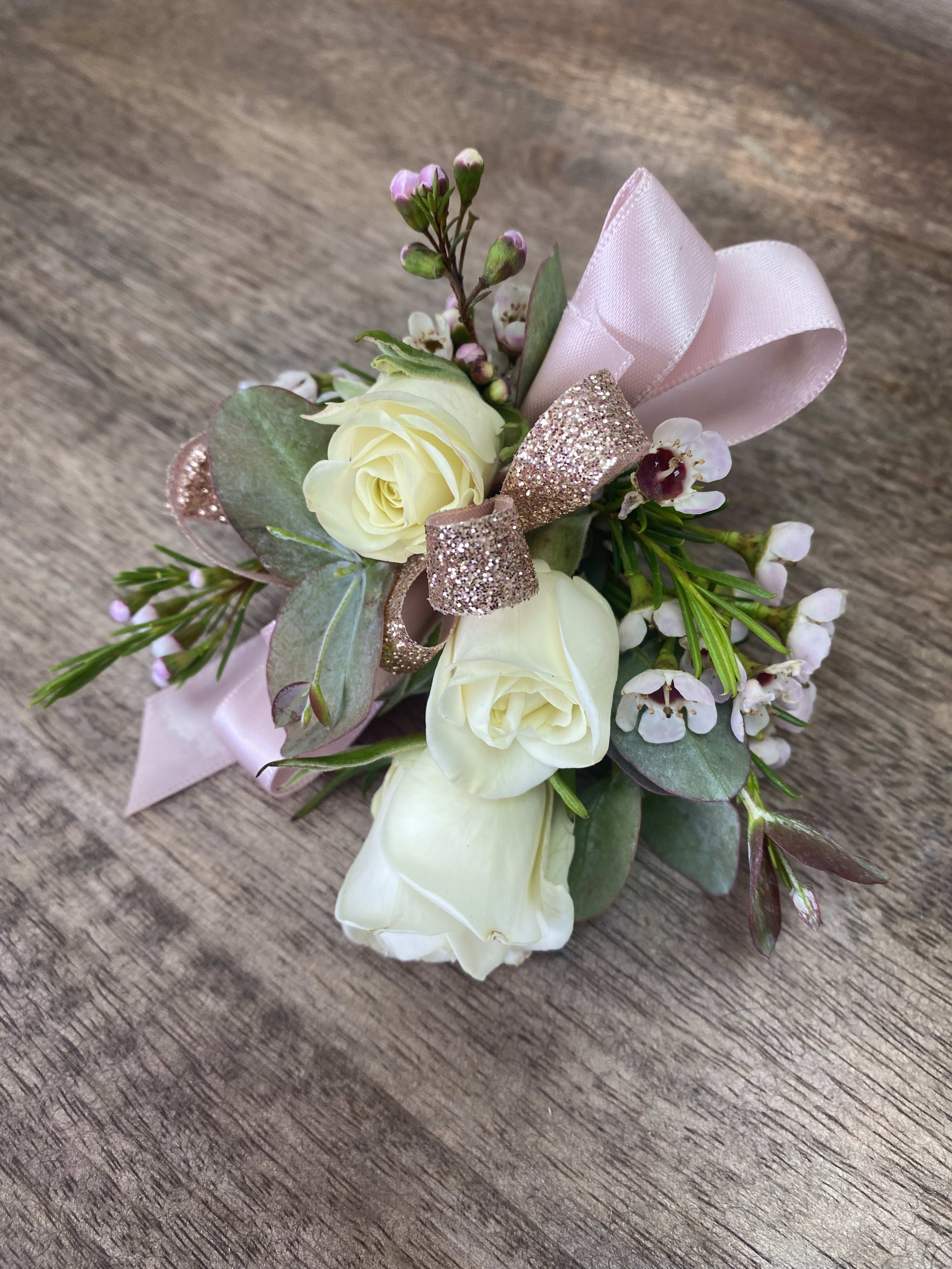 Small bouquet of white roses with pink ribbon and glitter bow