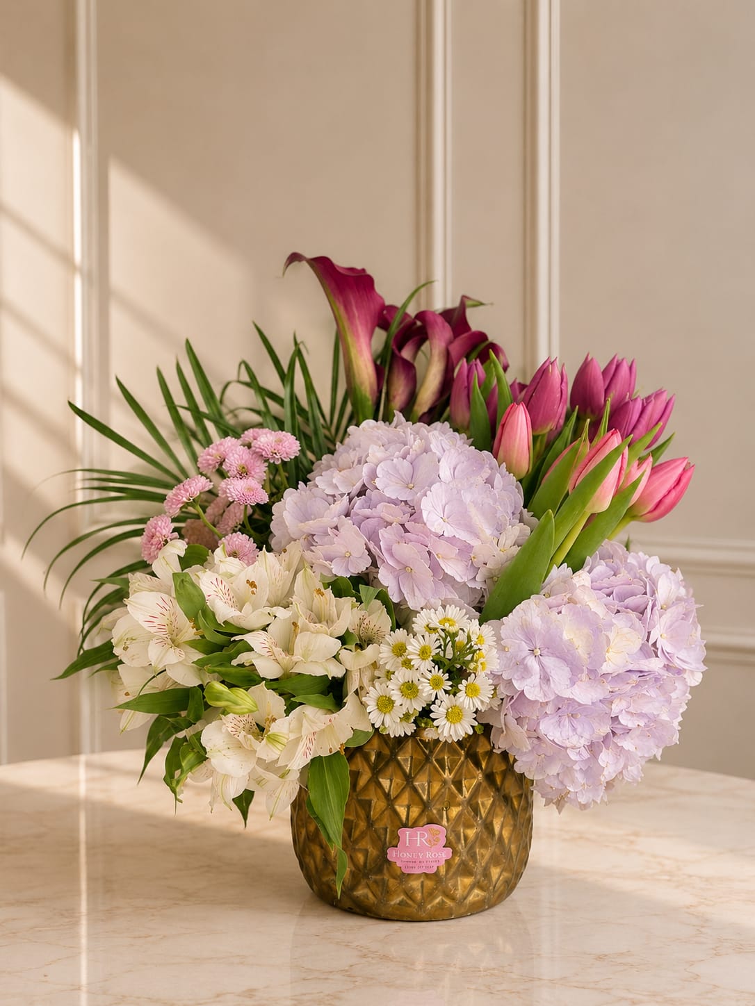     Spring Tulip Elegance - A fresh garden-style arrangement featuring tulips, hydrangeas, calla lilies, and delicate seasonal blooms in soft pastel tones.