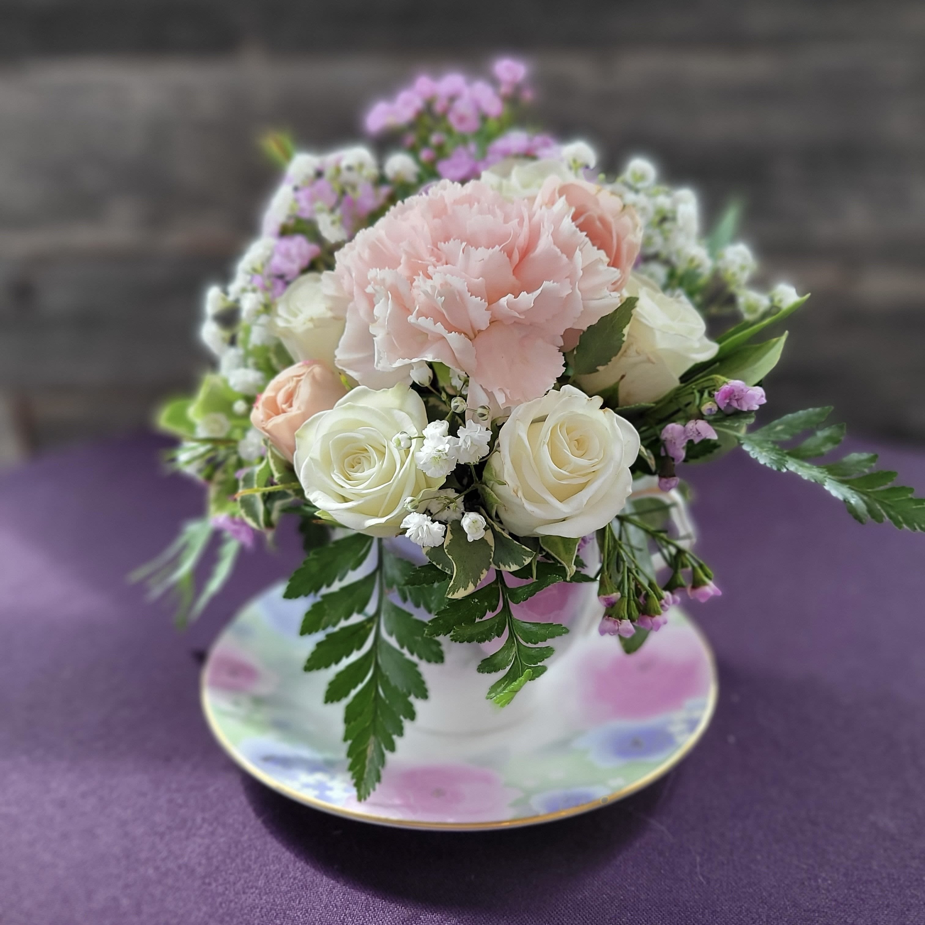  Victorian Whimsy - Sweet as a garden tea party, this arrangement pairs soft pastels and creamy blooms in a dainty floral teacup. A perfect  gift for mothers, grandmothers, or anyone who deserves a little elegance  with their day  
