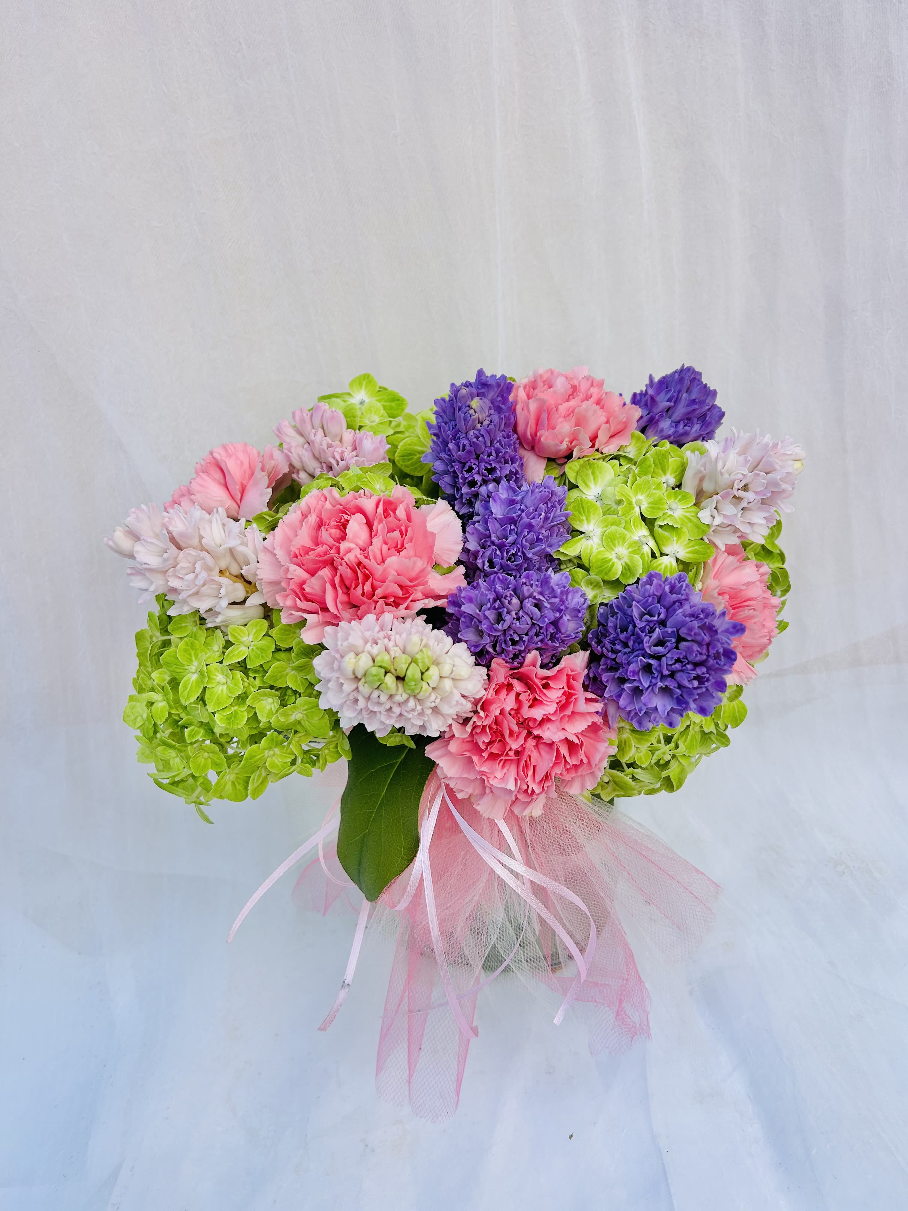 Bunches of Hyacinth - Beautiful arrangement featuring lavender and purple hyacinths, pink carnations, and green hydrangeas. 
