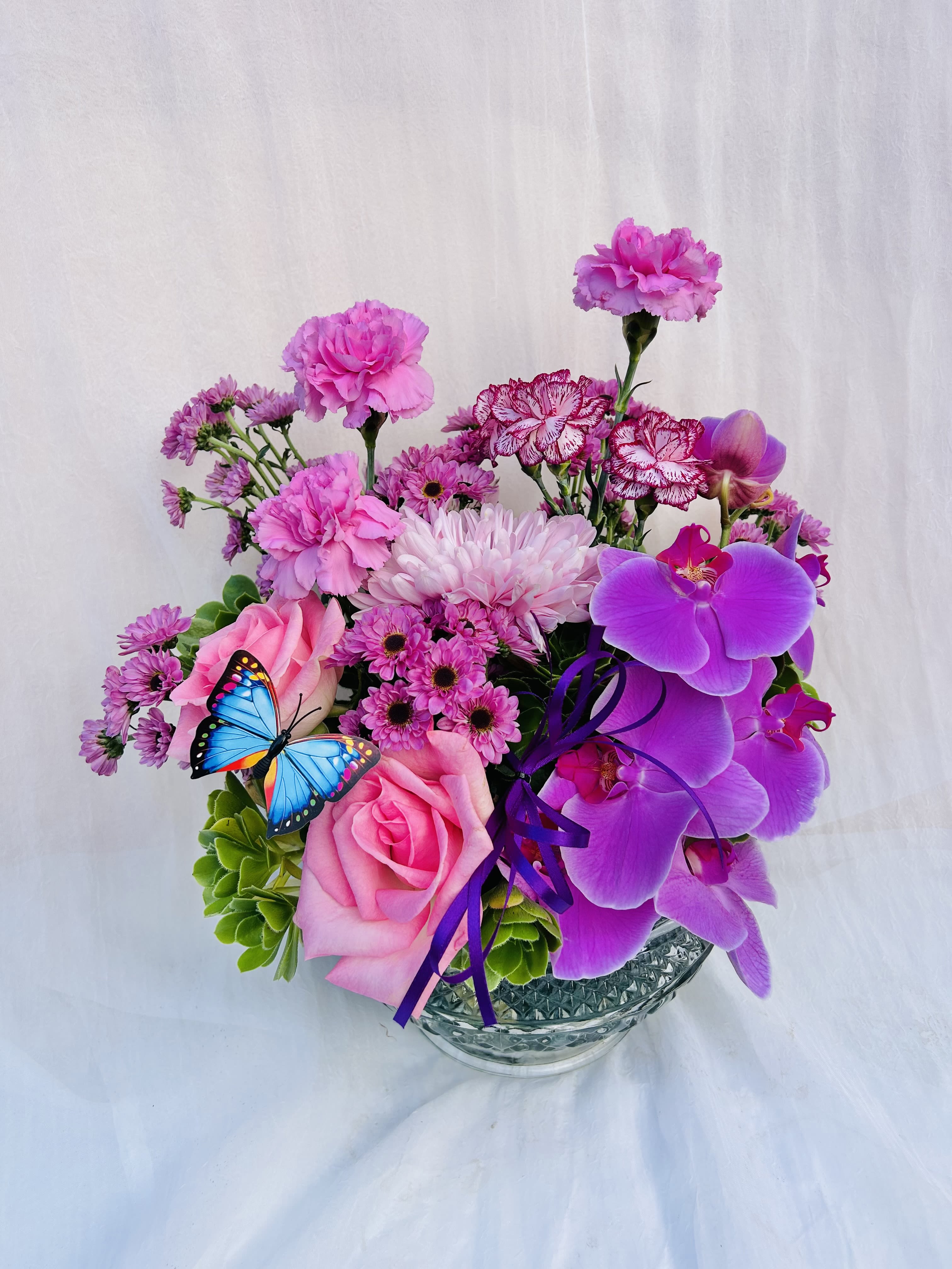 Velvet Orchid - Beautiful arrangement featuring pink roses, carnations, chrysanthemums, purple orchids, and green accents. 