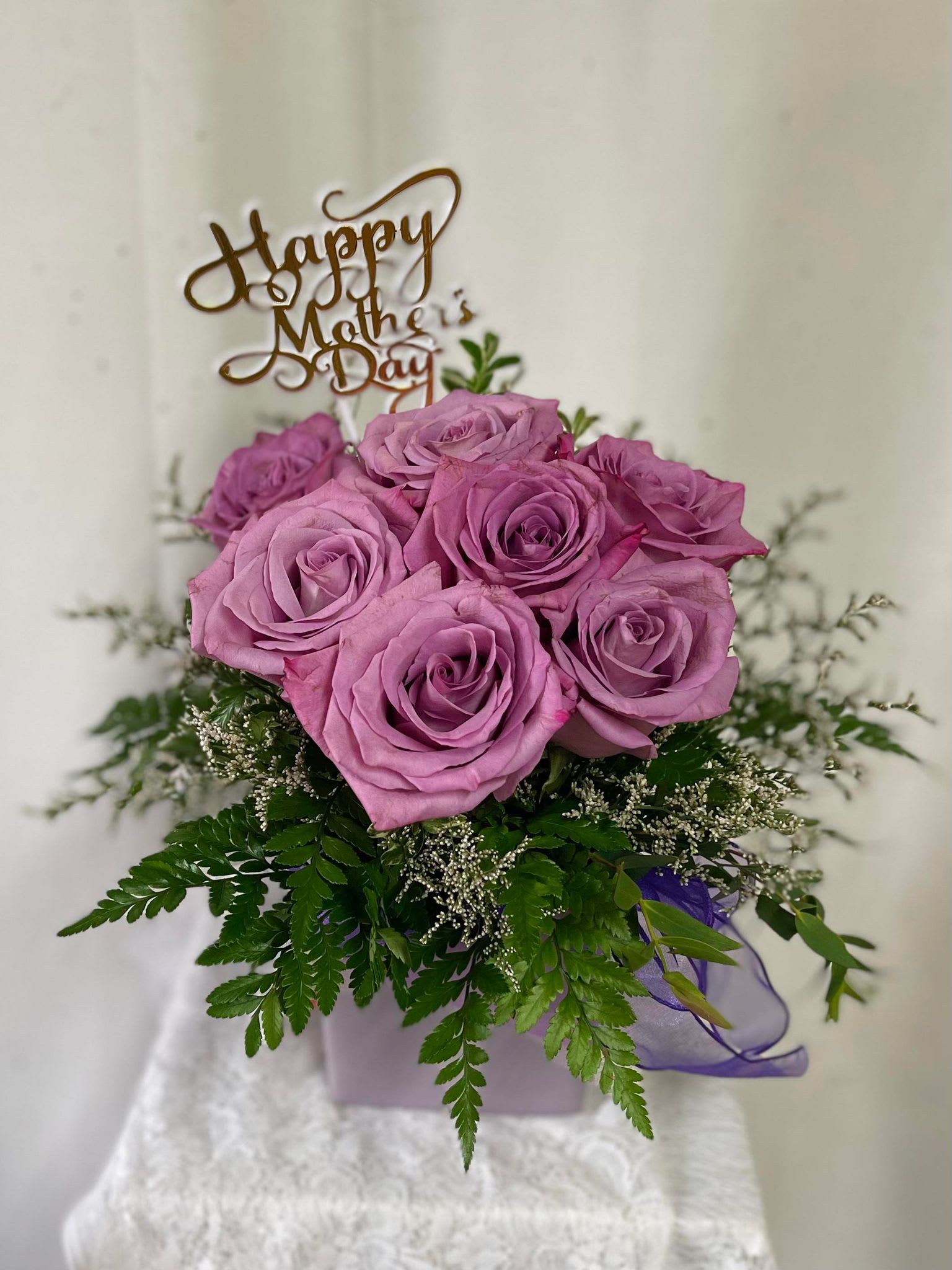 Pink rose bouquet in a lavender box with a Mother's Day topper