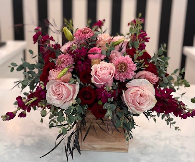 Pink and red rose arrangement in a wooden box