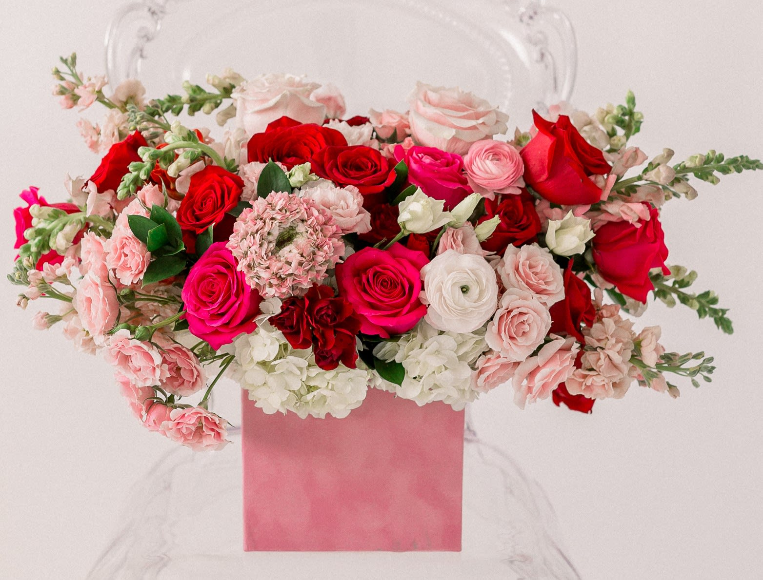 Pink and red rose arrangement in a pink box