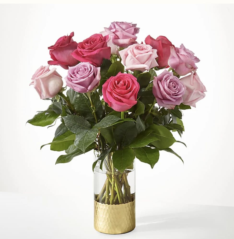 Bouquet of pink and lavender roses in a glass vase
