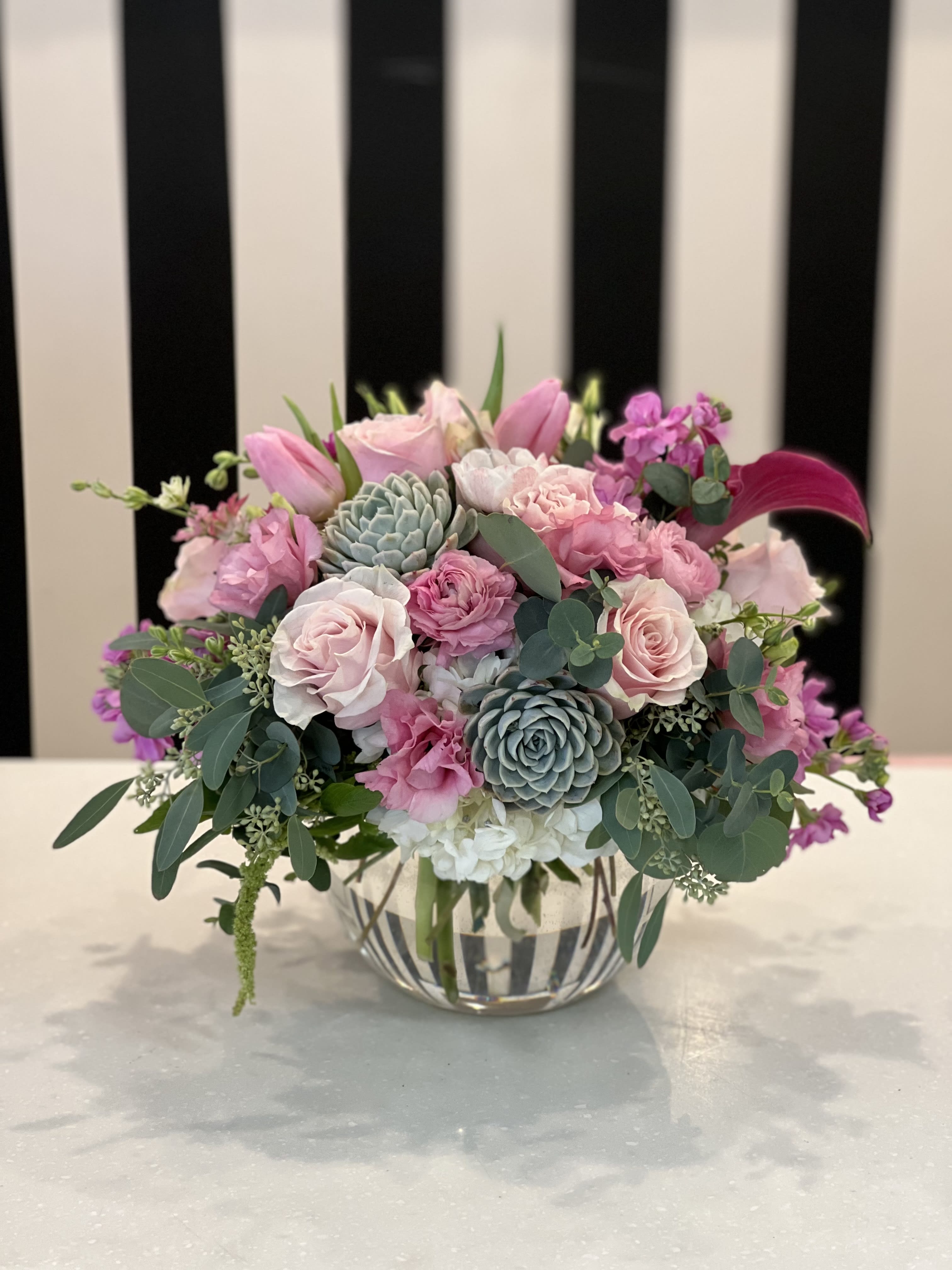 Pink and white floral arrangement in a clear glass vase