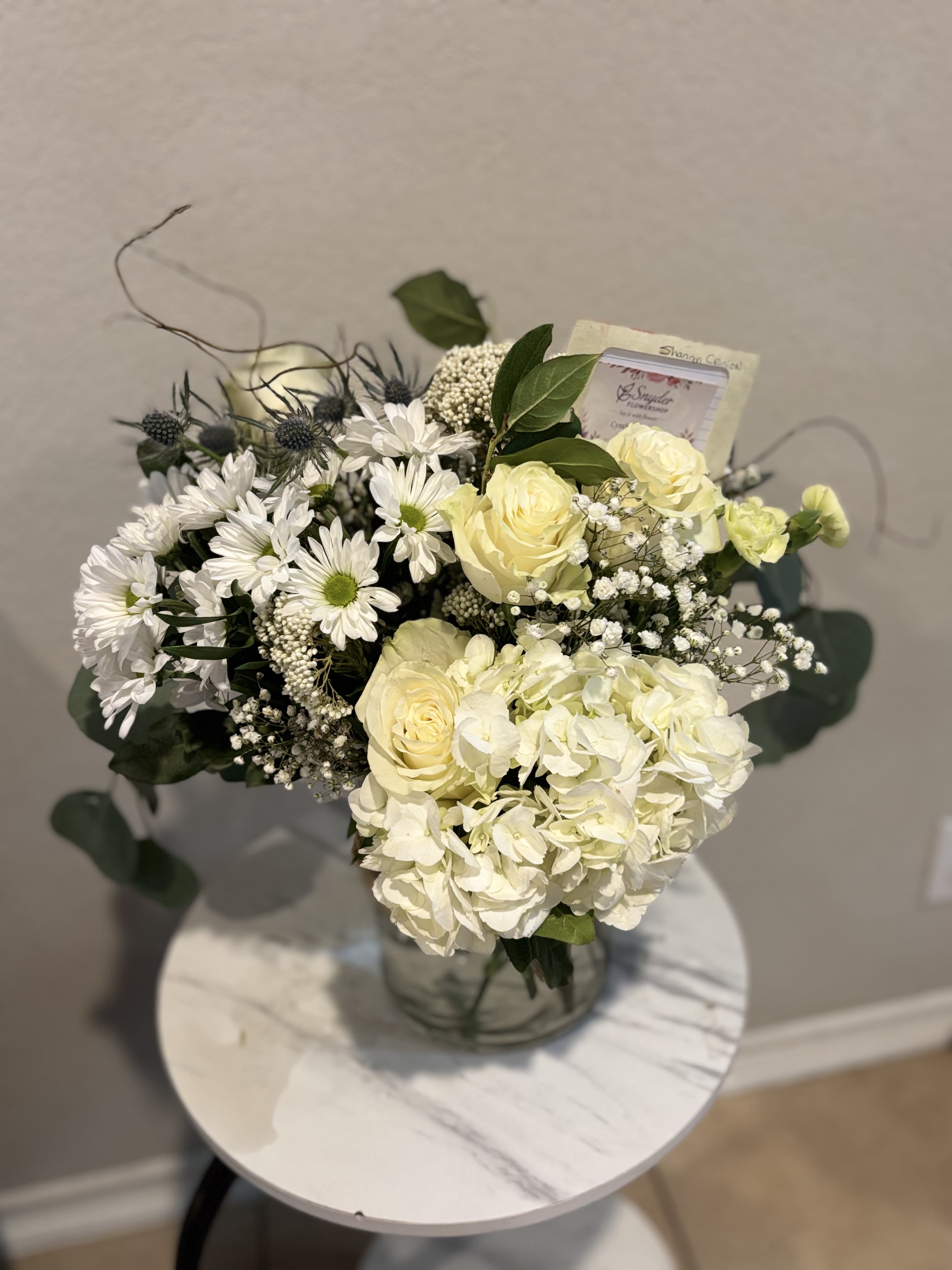 Elegant White Hydrangea &amp; Rose Arrangement - Elegant white hydrangeas, white roses, daisies and baby’s breath arranged in a luxury floral design by Snyder Flower Shop in San Antonio, TX. Perfect for sympathy flowers, anniversaries, birthdays and Mother’s Day flower delivery. Fresh handcrafted flower arrangements available for same day delivery in San Antonio.