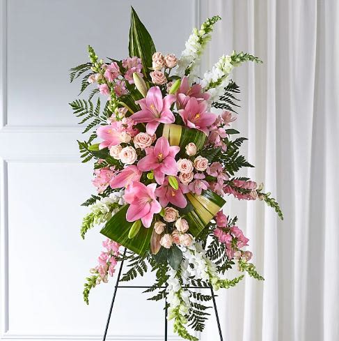 Elegant Standing Spray -  Pet Friendly? No - This arrangement contains Oriental Lilies, which are highly toxic to cats even in small amounts.  Keep out of reach of all household pets and avoid sending this to homes with curious cats.   Human Allergy Note : This arrangement contains pollen-heavy Oriental Lilies and Pink Alstroemeria. To minimize irritation, you can carefully snip the orange anthers from the center of the lilies as they open and ensure the service area is well-ventilated.   Care &amp; Longevity : Since this is a foam-based spray, it requires regular hydration to stay fresh. Gently mist the blooms and pour a small amount of water into the center of the foam block daily. Keep the arrangement away from direct sun, harsh heat, or cooling vents, and remove any fading petals to keep the tribute looking its best.    Best Occasions &amp; Situations : - Funeral service tribute - Celebration of life ceremony - Memorial church service - Graveside honors - Expression of deep sympathy - Standing floral honor for a viewing   Why Customers Love It : - Soft Color Palette: The blend of blush and white offers a comforting, feminine aesthetic. - Impressive Height: The vertical design ensures the tribute is easily seen during services. - Long-Lasting Blooms: Features hardy flowers like Snapdragons and Alstroemeria. - Traditional Elegance: A timeless way to show support when ordering flowers Nashville.