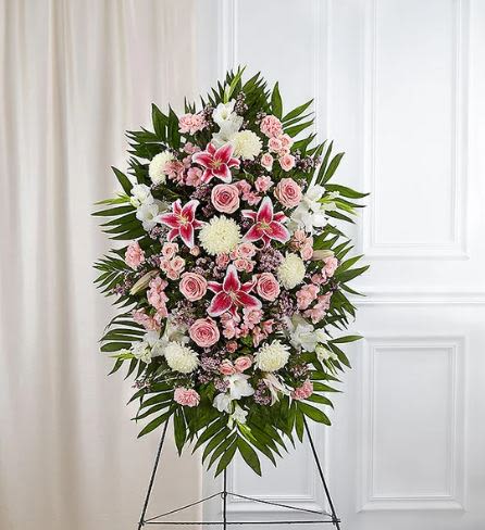 Pink Standing Spray -  Pet Friendly? No - This arrangement contains Stargazer Lilies, which are highly toxic to cats and can cause kidney failure even in small amounts.  Chrysanthemums are also irritants to household pets. Keep this arrangement on its stand and away from curious animals.   Human Allergy Note : This arrangement contains pollen-heavy Lilies and Mums. We recommend removing the orange anthers from the lilies as they open to reduce airborne pollen and prevent fabric staining.   Care &amp; Longevity : Since this is arranged in floral foam, it requires daily “topping off.” Gently pour water into the back of the foam block to keep it saturated, and mist the petals lightly to maintain hydration. Keep the spray in a cool area away from direct sunlight or heating vents to extend the life of the blooms.   Best Occasions &amp; Situations : - Funeral service tribute - Memorial or Celebration of Life - Church sanctuary display - Graveside service - Sympathy gesture for a family   Why Customers Love It : - High-impact size that stands out in large rooms. - Balanced color palette of soft pinks and crisp whites. - Professional presentation on a sturdy, included wire easel. - Symbolic blooms like lilies and roses that convey deep respect. - Fresh selection of flowers Nashville locals trust for quality.
