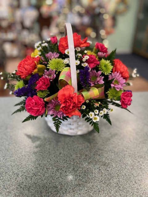 Colorful mixed flower basket with a white handle