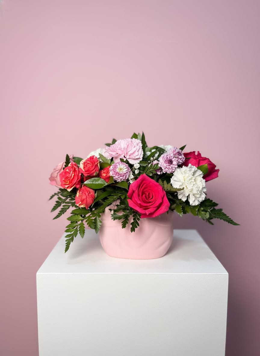 Sweetheart Pink Arrangement - The Sweetheart Pink arrangement includes pink and red roses with ruffled carnations and soft white and lavender touches creating an immediately romantic, cheerful impression. Perfect as a birthday bouquet, anniversary arrangement, or Mother's Day gift!  This arrangement is sized for easy display and everyday enjoyment; recommended for someone you want to make feel cherished and seen. Water upon arrival and trim stems if needed to extend vase life-perfect for sending heartfelt wishes that arrive looking fresh and polished.
