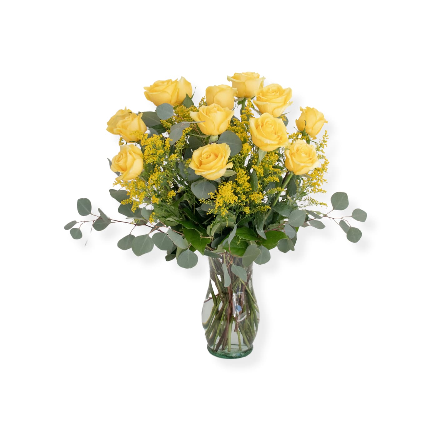 Yellow roses arranged in a clear glass vase with airy filler and eucalyptus
