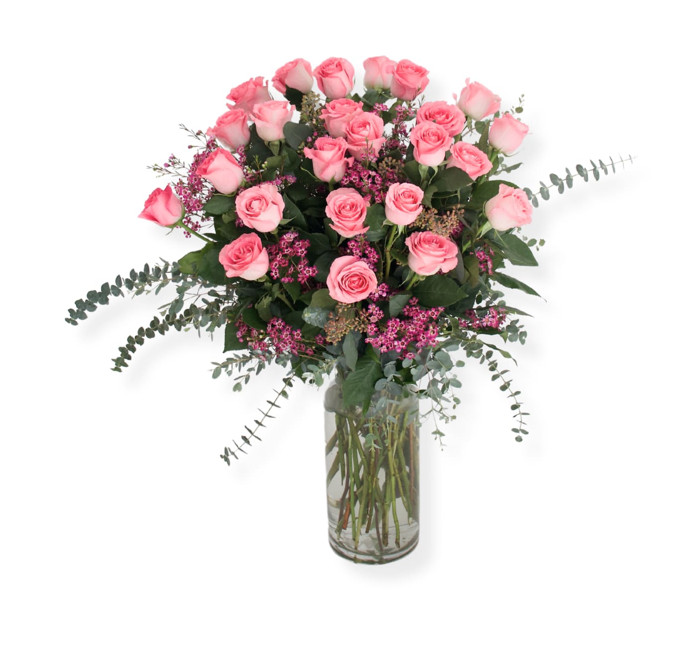 Pink roses arranged in a clear glass vase with small pink filler flowers