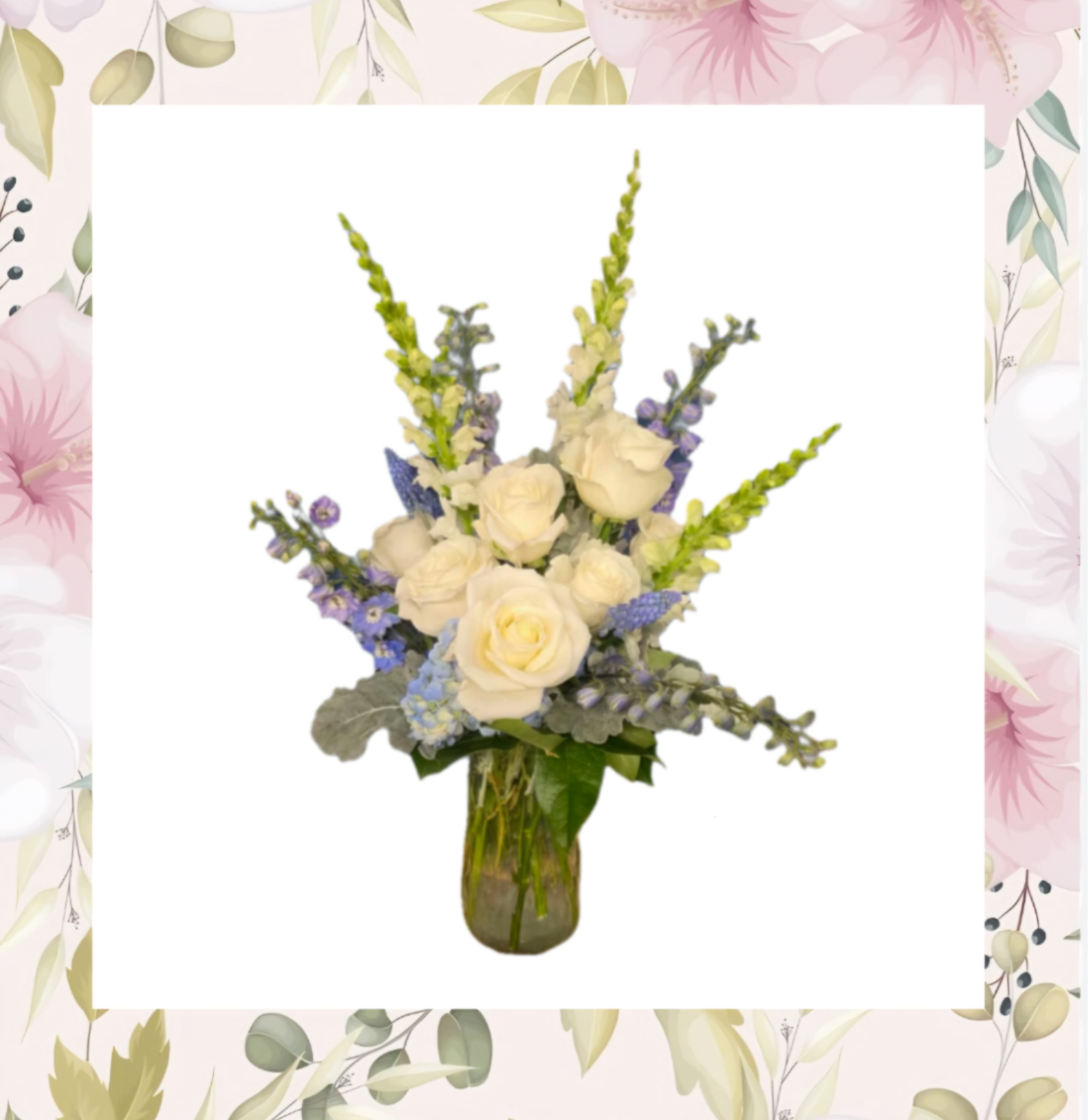 White roses and blue flowers arranged in a glass vase
