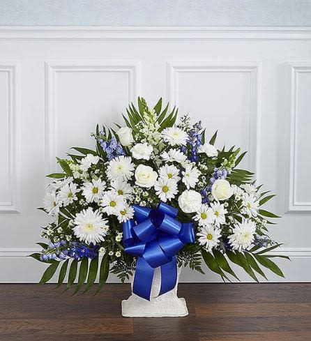 Heartfelt Tribute Blue Floor Basket - Pet Friendly? No - This arrangement contains mums and daisies, which can cause gastrointestinal upset or dermatitis in household pets if ingested.  Keep out of reach; avoid homes with curious cats or dogs.  Human Allergy Note : This arrangement is pollen-heavy due to the inclusion of mums, daisies, and asters. To minimize irritation, keep the basket in a well-ventilated area and avoid placing it directly next to individuals with known hay fever or pollen sensitivities.  Care &amp; Longevity : To keep these blooms fresh, check the water level daily by feeling the floral foam inside the basket; it should always be damp to the touch. Gently add water to the center of the foam, avoiding the blue satin ribbon.   Best Occasions &amp; Situations : - Funeral service at a chapel or church - Celebration of life ceremony - Memorial service floor display - Sympathy gesture for a grieving family - Military honors tribute (due to the patriotic blue/white theme) - Graveside service  Why Customers Love It : - Striking Color Contrast: The bold blue against the pure white creates a visually stunning and memorable tribute. - Substantial Size: This floor basket has the height and width needed to fill a large space at a service. - Gift-Ready: Arrives fully arranged in a pedestal basket with a decorative blue ribbon, requiring no extra setup. - Symbolic Meaning: Uses flowers Nashville families trust to convey peace, honor, and deep respect.