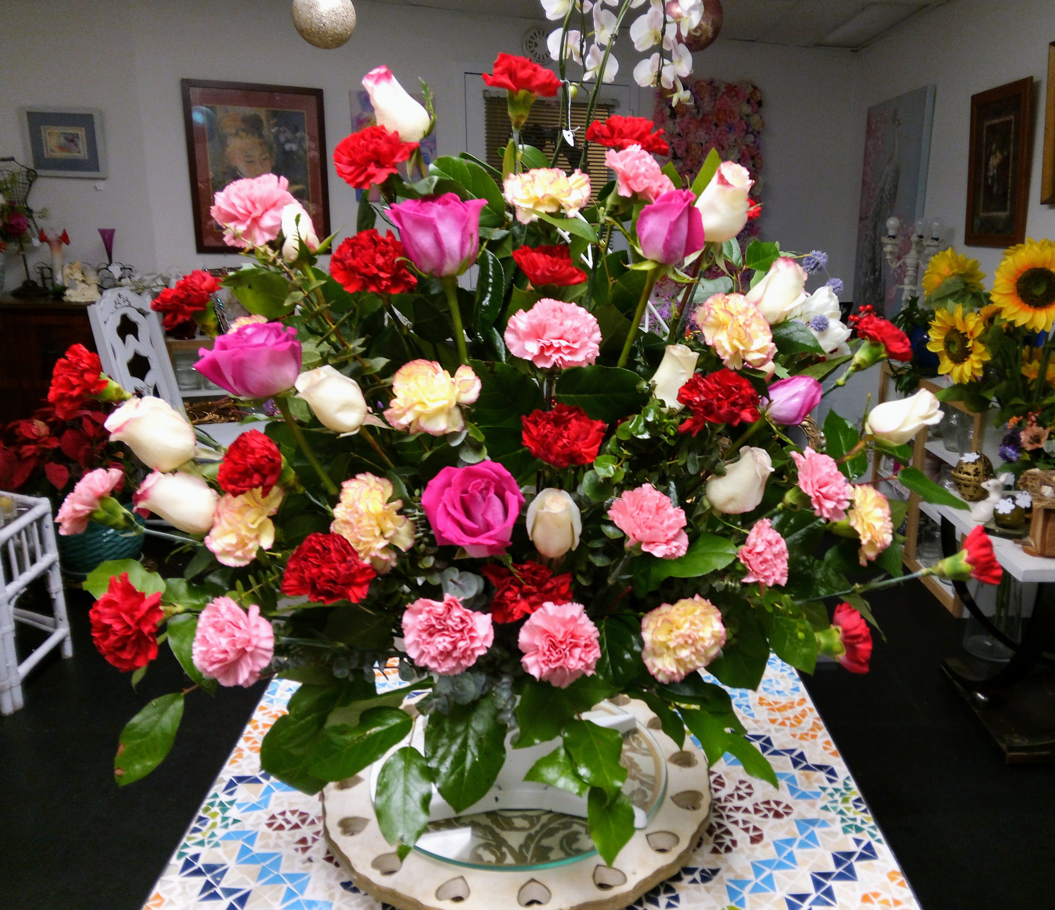 Large mixed bouquet of roses and carnations in a vase